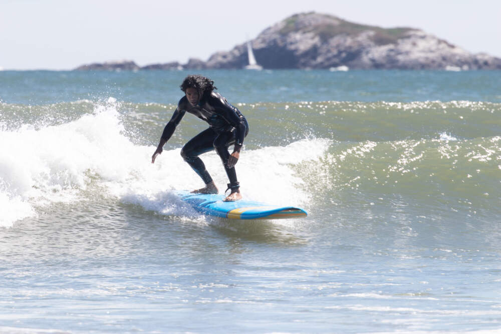 A surfer rides the waves at Nahant Beach. (Photo courtesy of Grant Gary/Boston Surf Adventures)