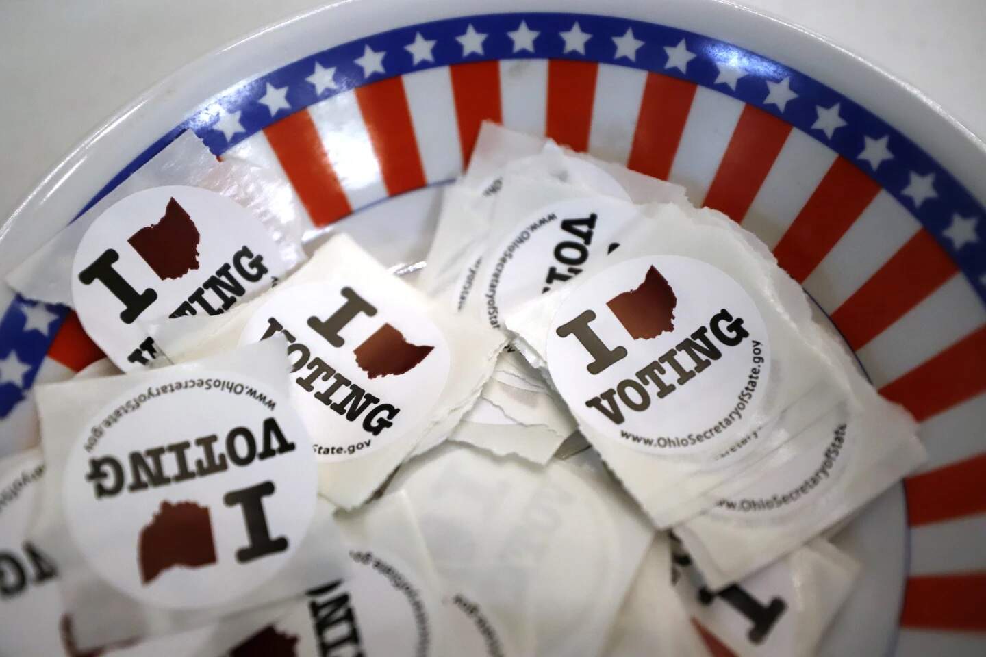 A bowl of voting stickers for early voters is show March 15, 2020, in Steubenville Ohio. (Gene J. Puskar/AP)