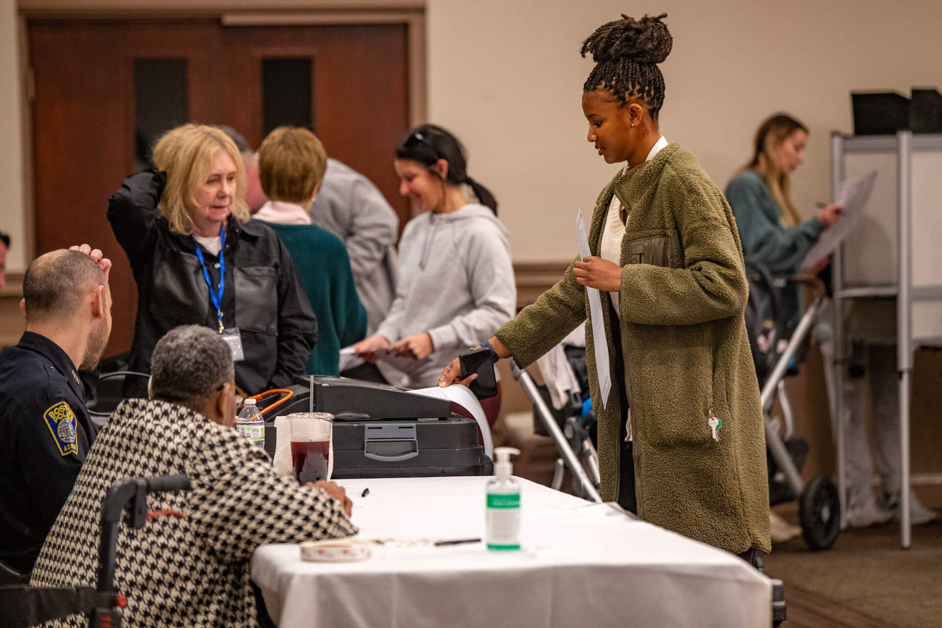 A voter inserts a ballot into the ballot machine at Florian Hall in Dorchester. (Jesse Costa/WBUR)