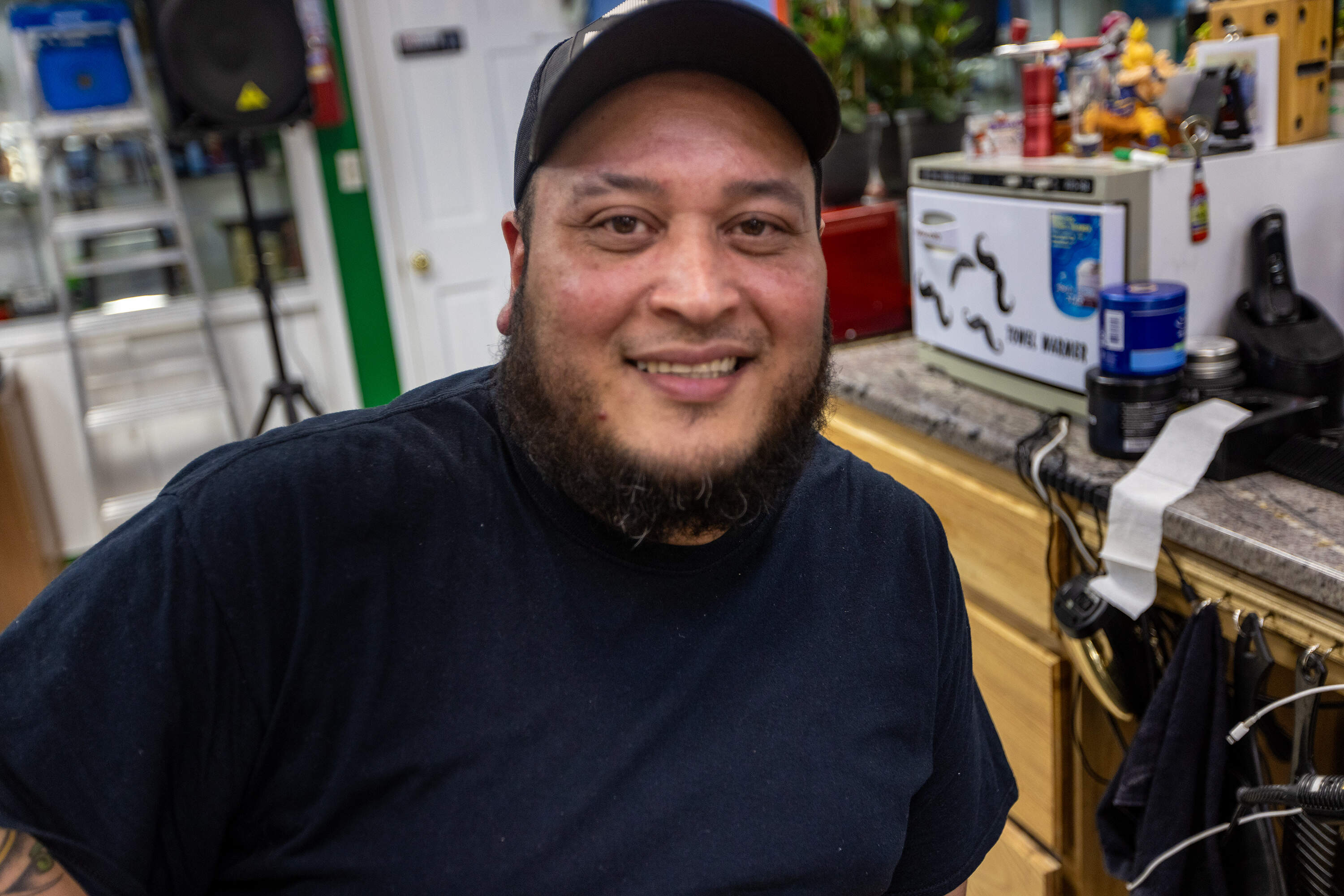Lawrence barber Pedro Julio Bastardo thinks Democrats have gone too far on LGBT issues. (Jesse Costa/WBUR)