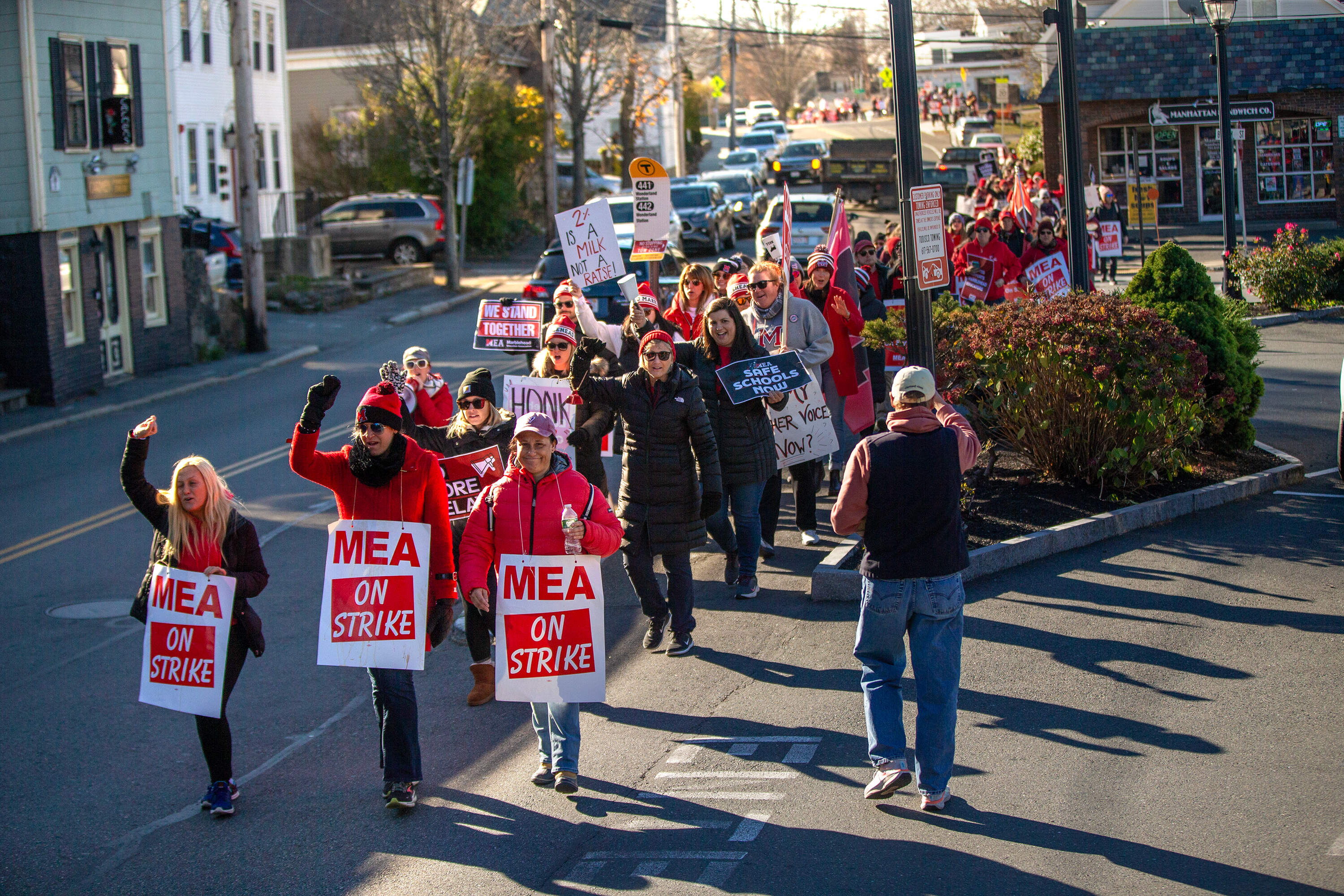 Teachers walk through Marblehead Center during a march on the fourth day of their strike. (Jesse Costa/WBUR)