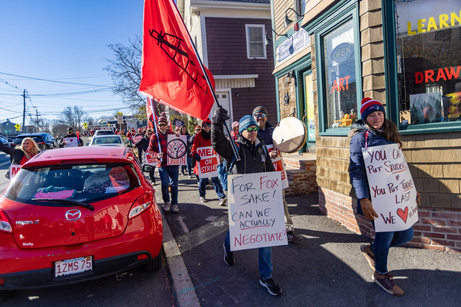 Teachers walk through Marblehead Center during a march on the fourth day of their strike. (Jesse Costa/WBUR)