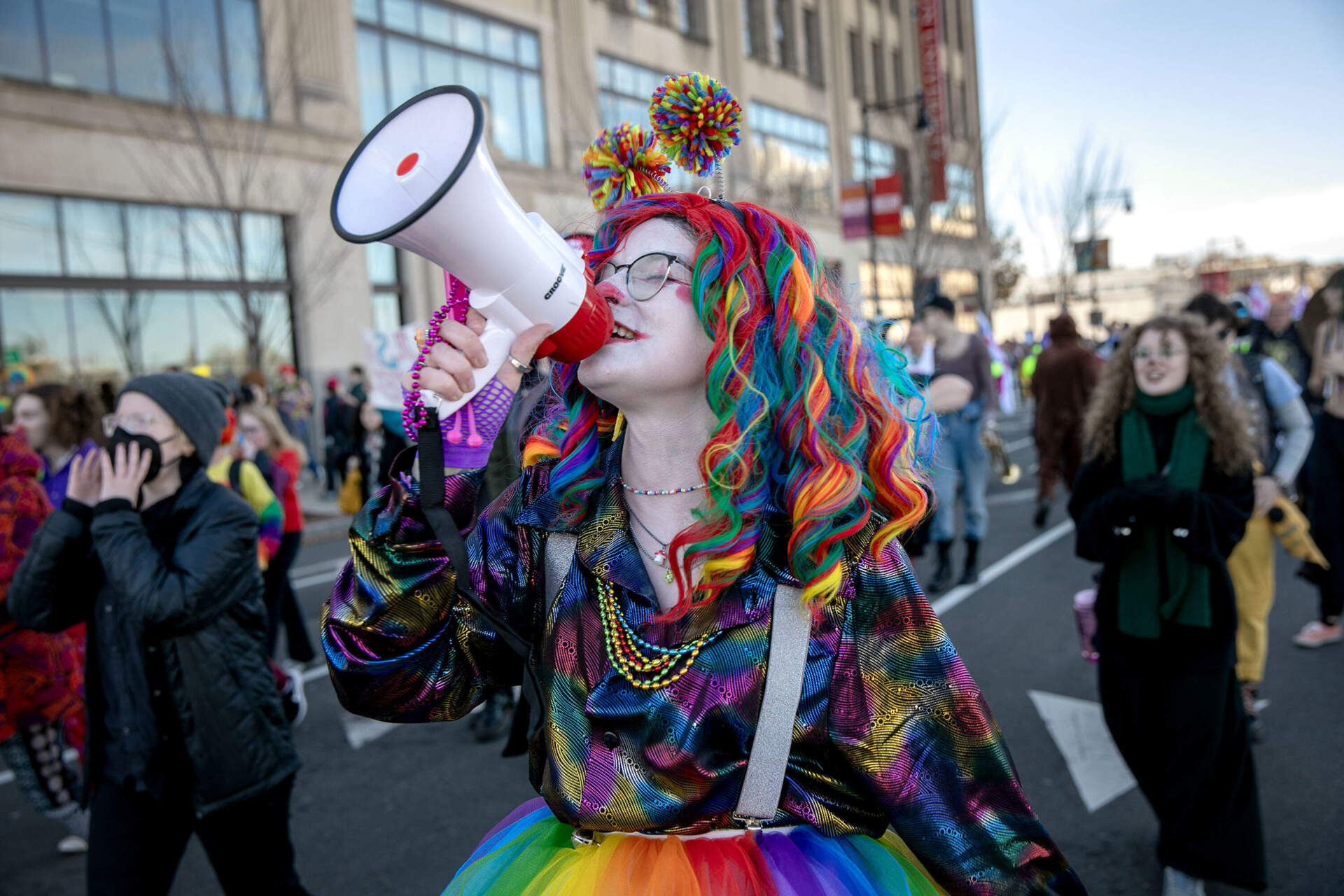A group of counter-protesting clowns walk ahead of the anti-abortion Men's March as it proceeds down Commonwealth Ave. (Robin Lubbock/WBUR)