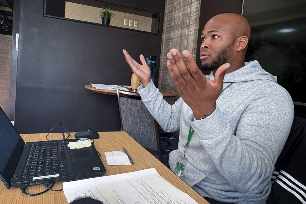 Wesbert Olivier Junior, a caseworker at an emergency shelter in Stoughton, helps families find housing and access government services. (Simón Rios/WBUR)