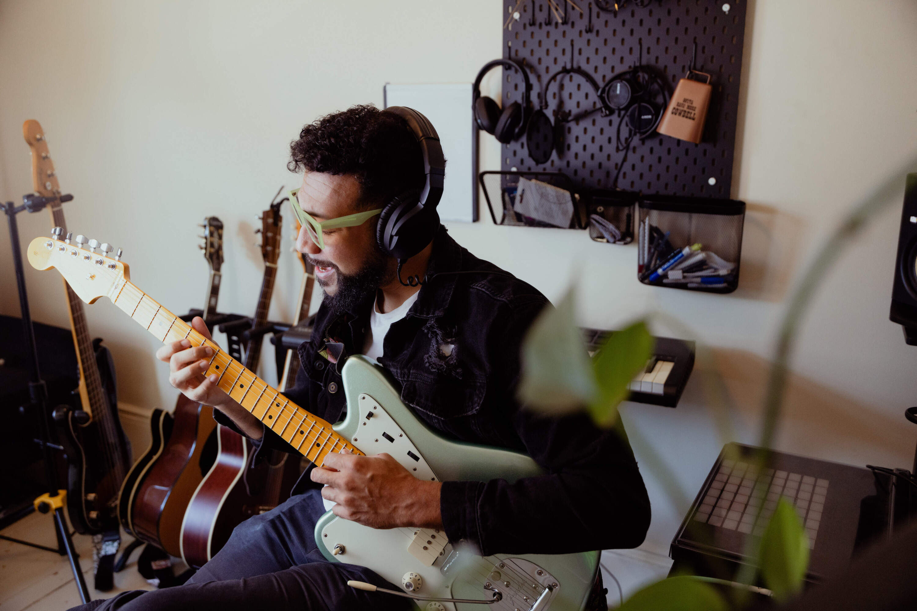 Chris Kazarian, who performs as Melo Green, works his Providence apartment where he writes and produces all his music. (Olivia Moon Photography for WBUR)