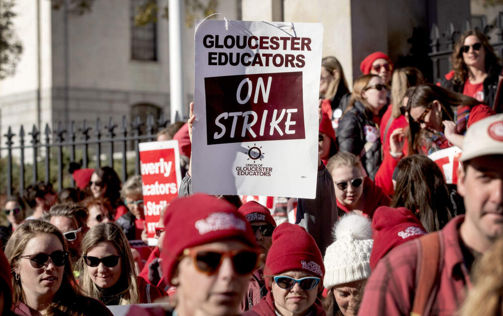 Striking teachers from various North Shore schools protest on the steps of the Massachusetts State House. (Robin Lubbock/WBUR)