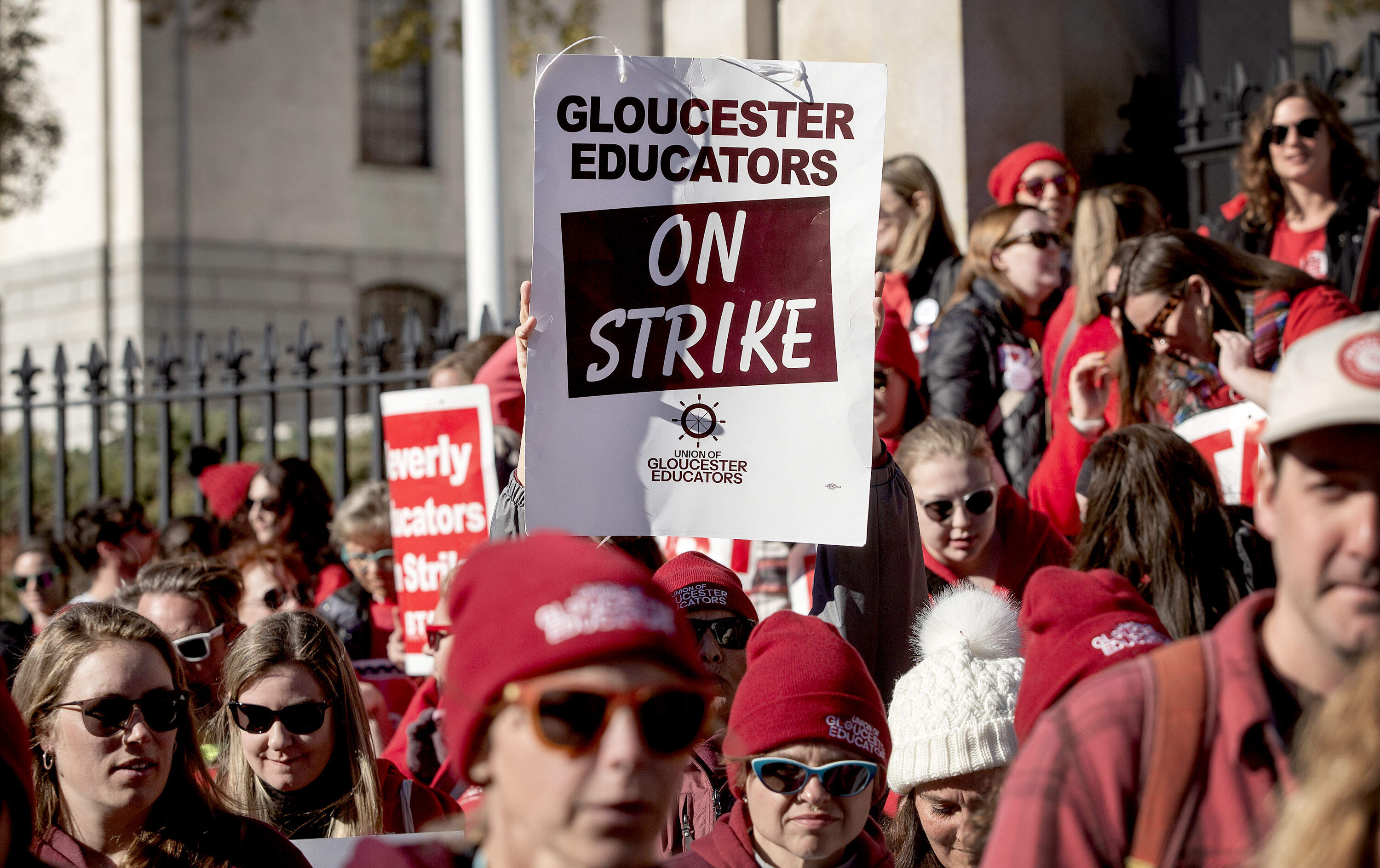 Striking teachers from various North Shore schools protest on the steps of the Massachusetts State House. (Robin Lubbock/WBUR)