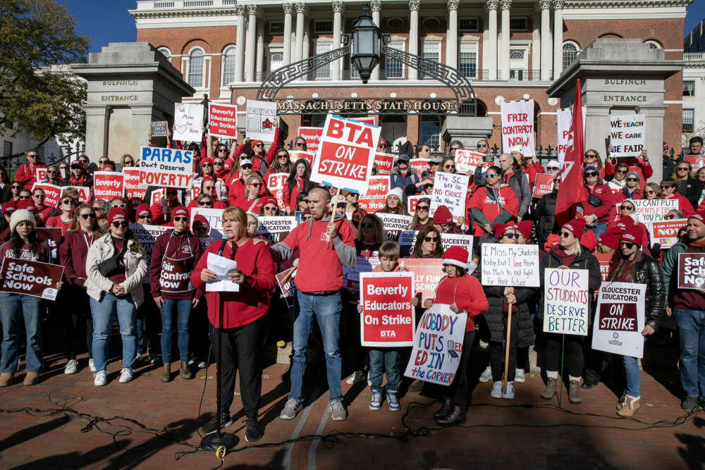 Beverly Public Schools teacher Leanne Harwood talks to striking teachers from various North Shore schools on the steps of the Massachusetts State House. (Robin Lubbock/WBUR)