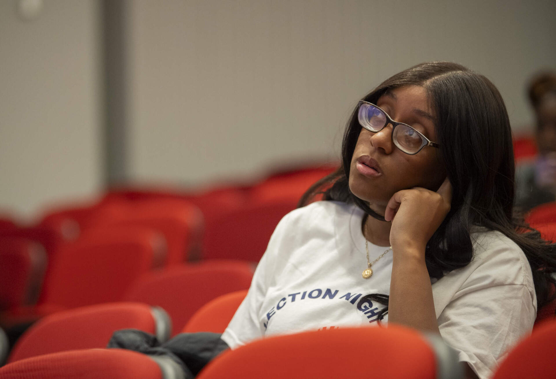 Tufts University student Maya Webb watches a newscast as polls begin to close on Nov. 5. (Amanda Sabga for WBUR)