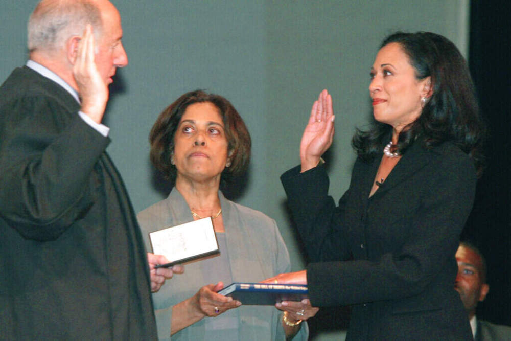 In this Jan. 8, 2004, file photo, San Francisco's new district attorney, Kamala Harris, right, receives the oath of office from California Supreme Court Chief Justice Ronald M. George, left, as Harris' mother, Dr. Shyamala Gopalan, holds a copy of &quot;The Bill of Rights.&quot; (George Nikitin/AP)