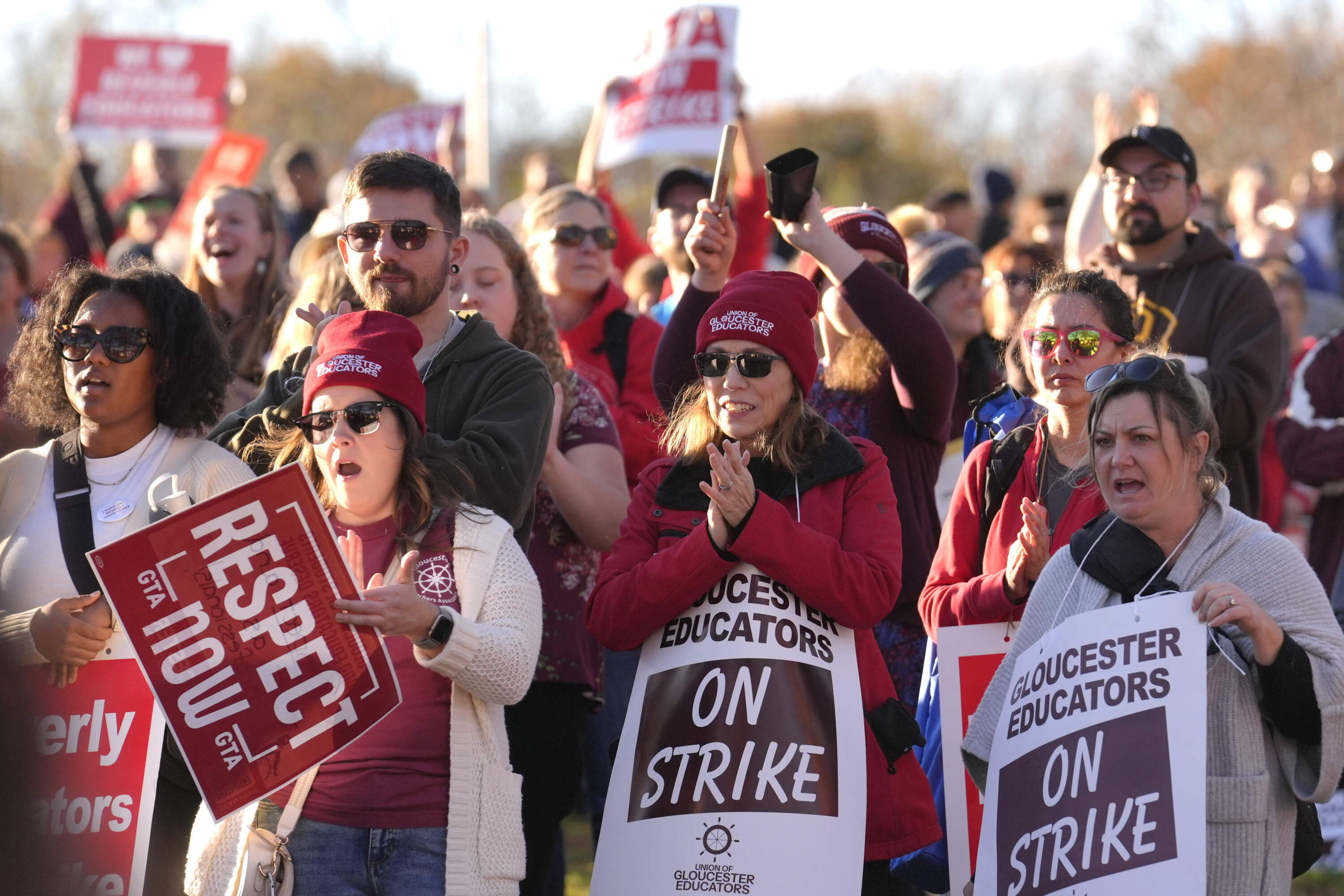 Supporters join striking teachers at a rally in Gloucester on Monday. (Steven Senne/AP)