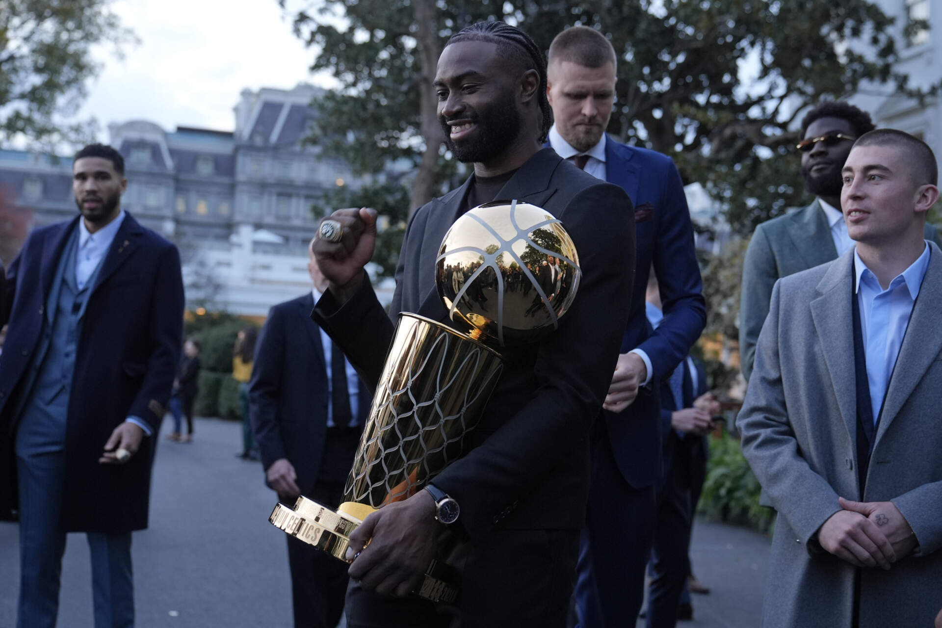 Boston Celtics player Jaylen Brown holds the Boston Celtics championship trophy following an event with President Joe Biden. (Susan Walsh/AP)