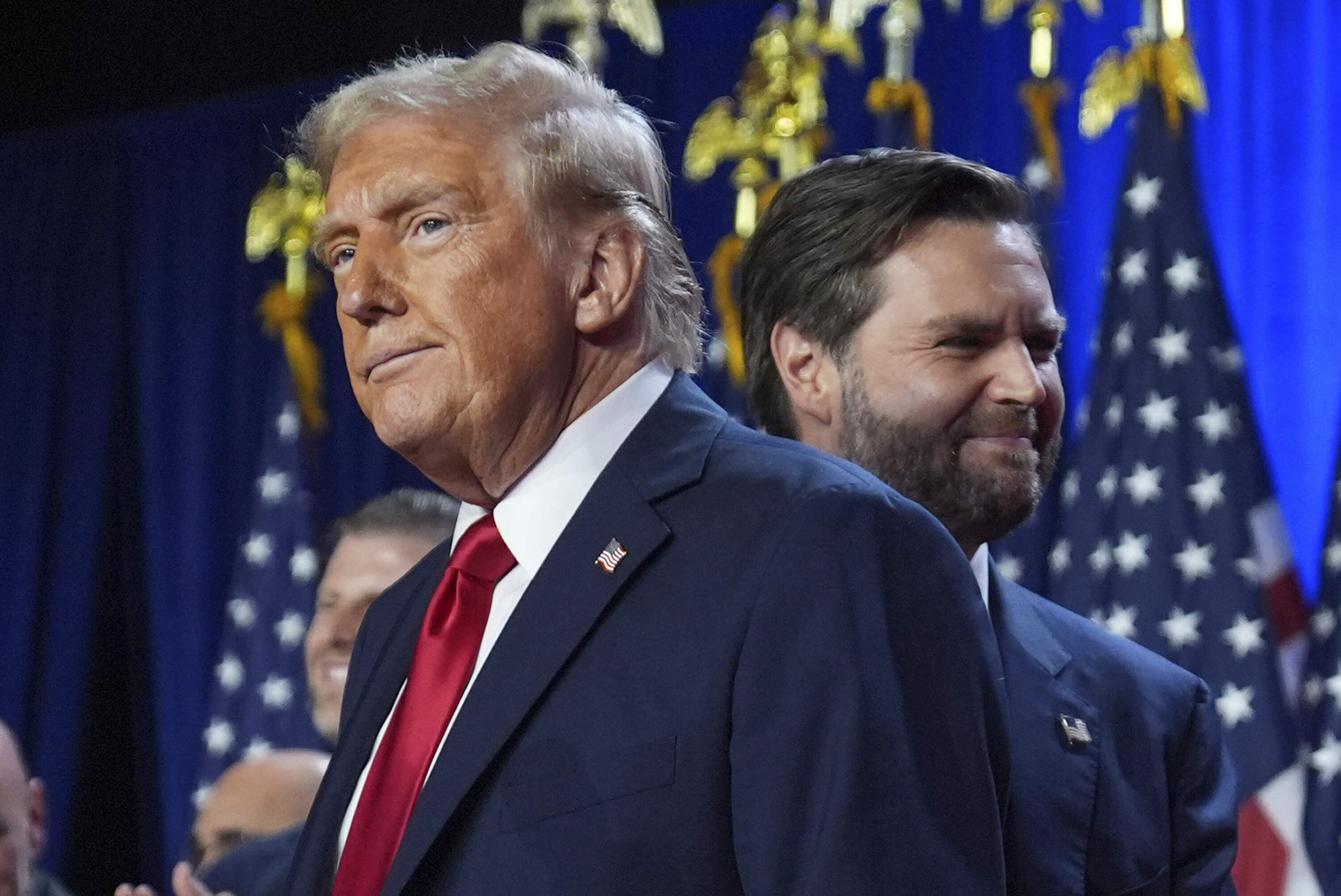 Trump and his running mate Sen. JD Vance stand on stage at an election night watch party at the Palm Beach Convention Center. (Evan Vucci/AP)