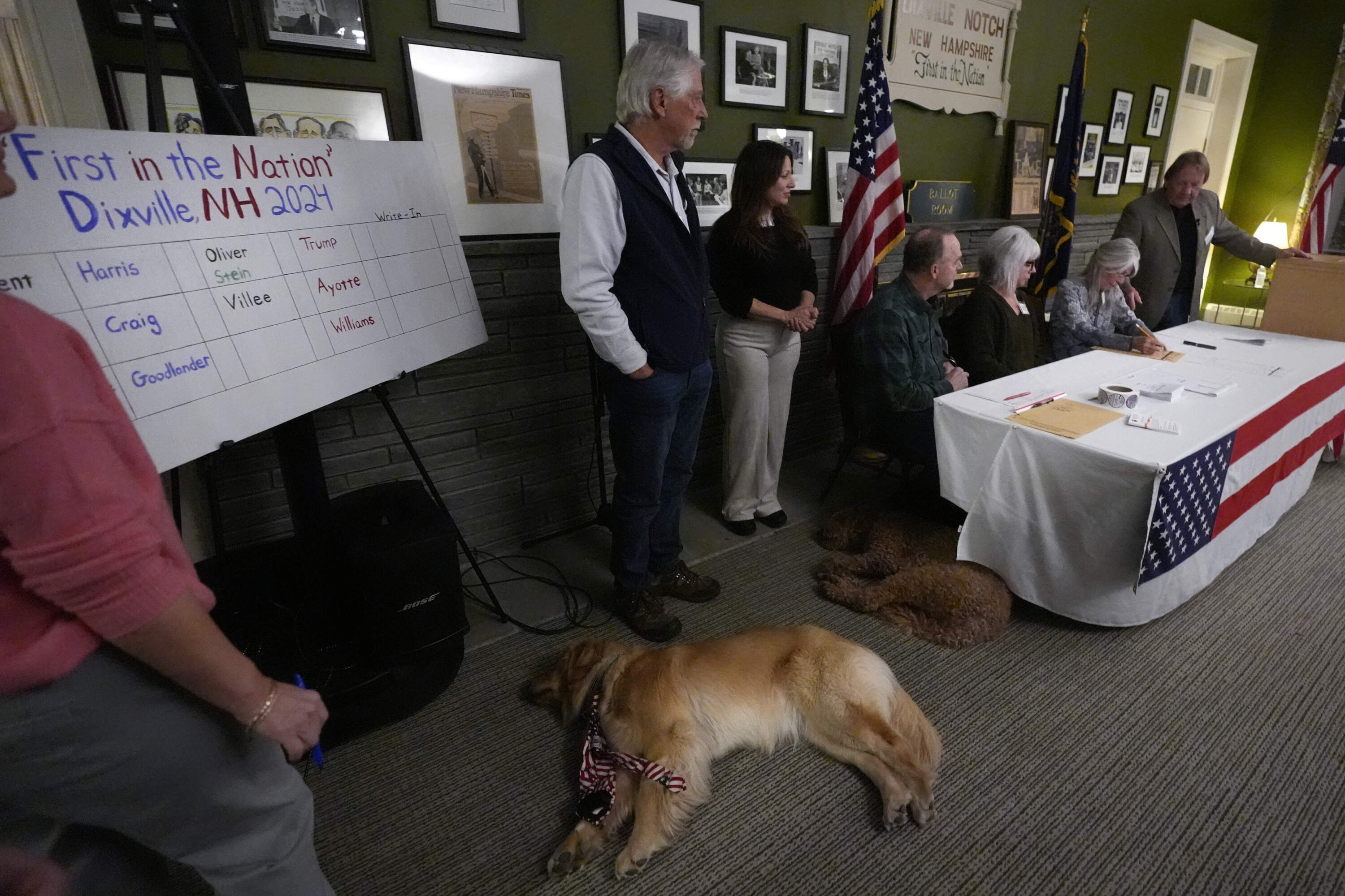 Town officials count the ballots as dogs lounge around on Election Day, Tuesday, Nov. 5, 2024, in Dixville Notch, N.H. (Charles Krupa/AP)