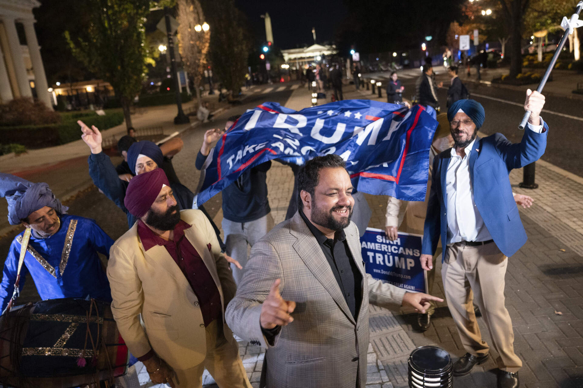 Supporters holding "Sikh Americans for Trump" signs dance outside the White House in Washington, Tuesday, Nov. 5, 2024. (Nathan Howard/AP)