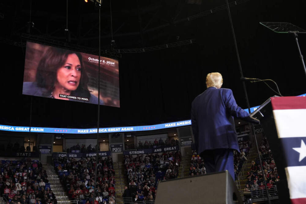 Republican presidential nominee former President Donald Trump watches a video of Democratic presidential nominee Vice President Kamala Harris as he speaks at a campaign rally at the Bryce Jordan Center, Saturday, Oct. 26, 2024, in State College, Pa. (AP Photo/Alex Brandon)