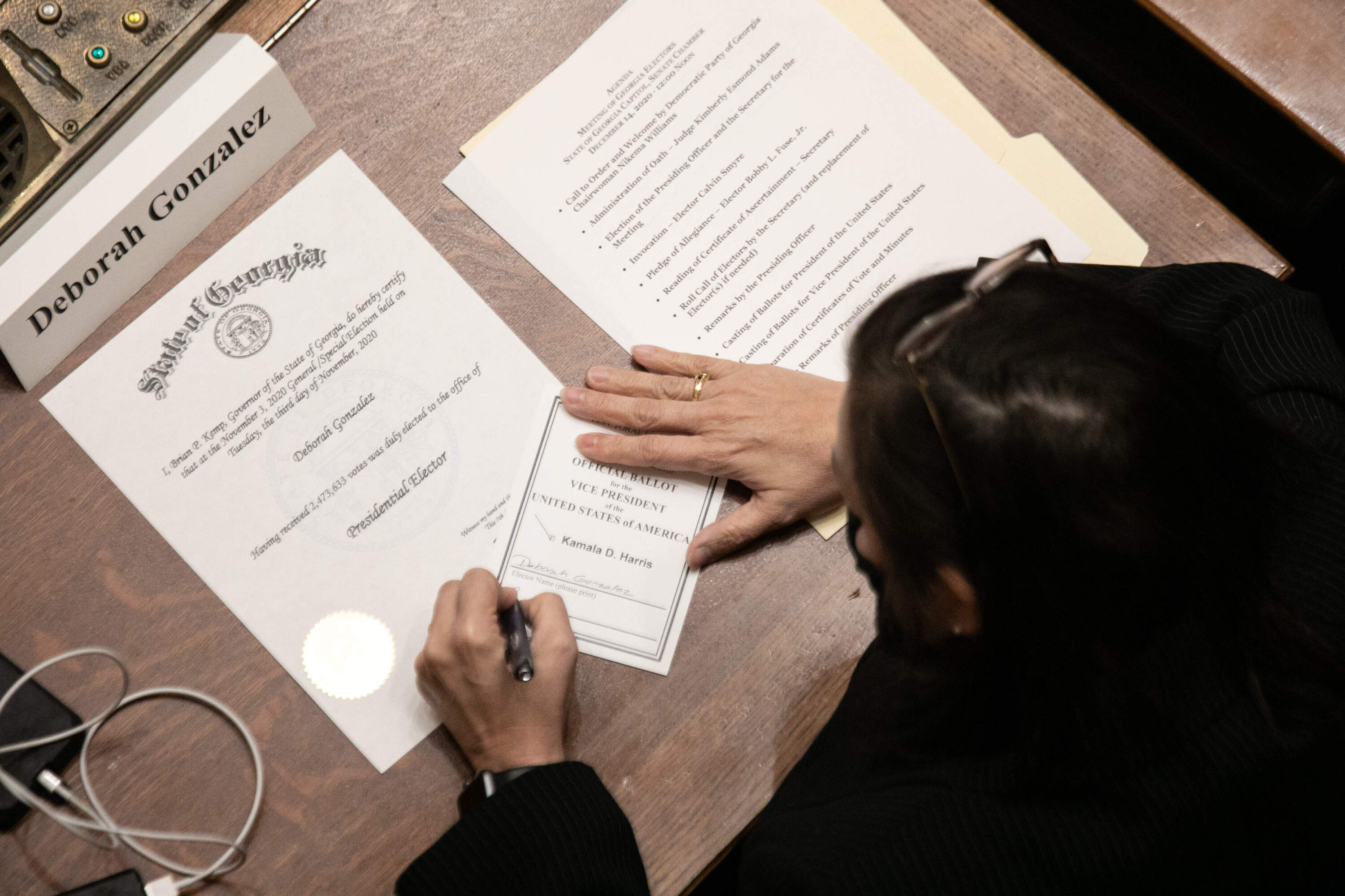 Georgia Democratic Elector Deborah Gonzalez signs a paper ballot solidifying her Electoral College vote for Kamala Harris as Vice President of the United States at the Georgia State Capitol on Dec. 14, 2020 in Atlanta, Georgia. (Jessica McGowan/Getty Images)