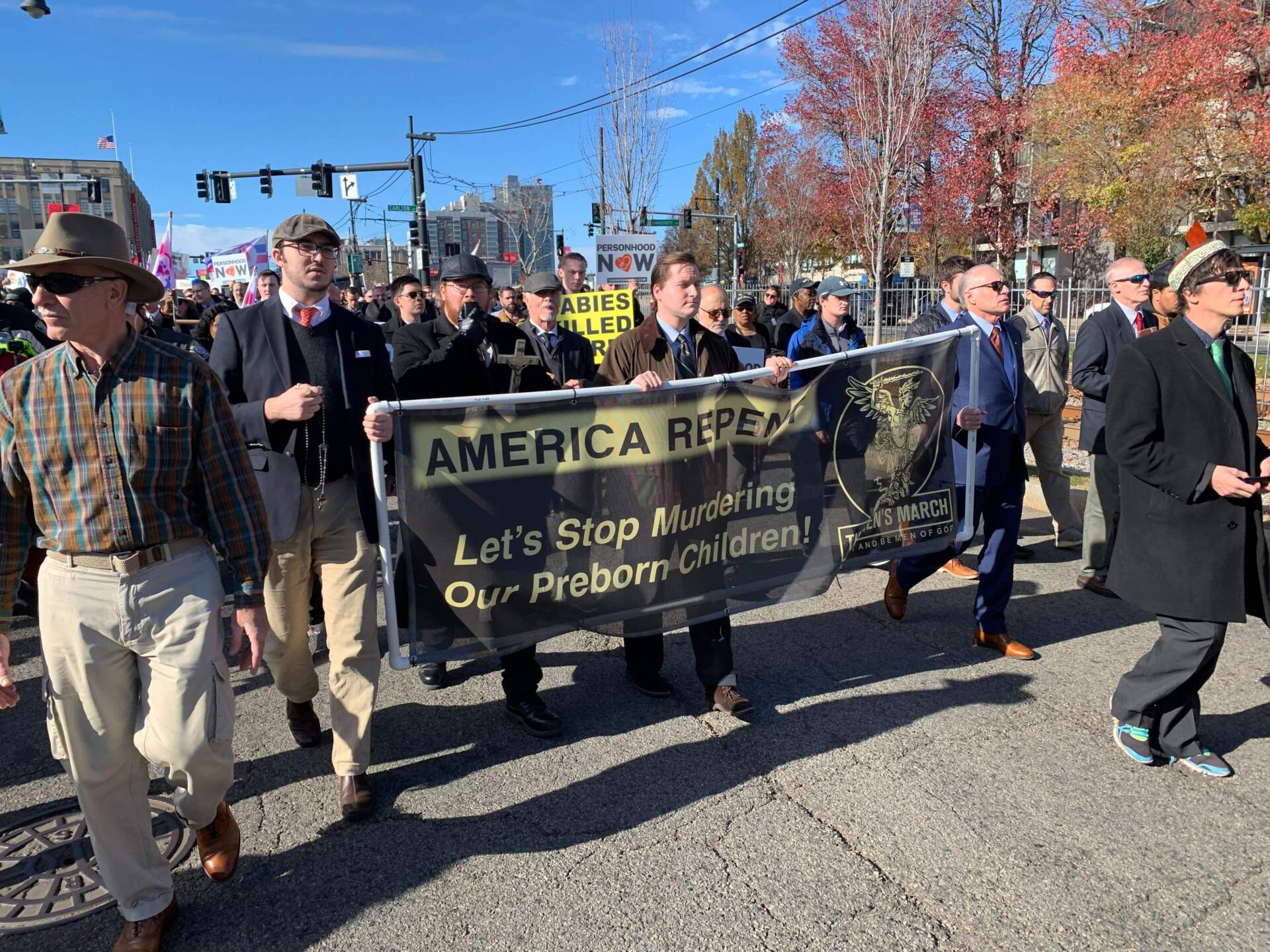 A group of anti-abortion demonstrators participating in what they called the "Men's March" walk down Commonwealth Avenue in Boston on Saturday, Nov. 16. (Robin Lubbock/WBUR)