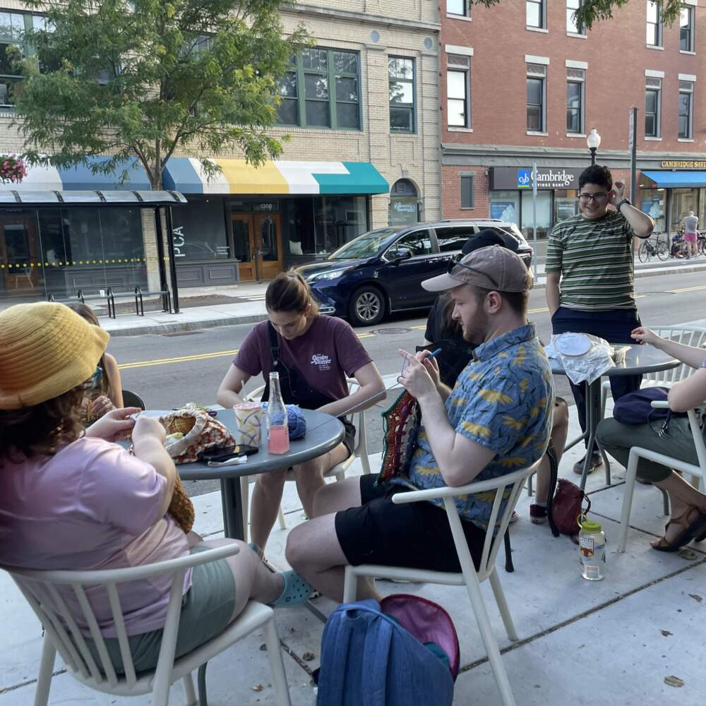 A craft group congregates at a public patio near Gather Here on Cambridge Street. (Image courtesy of Virginia Johnson)