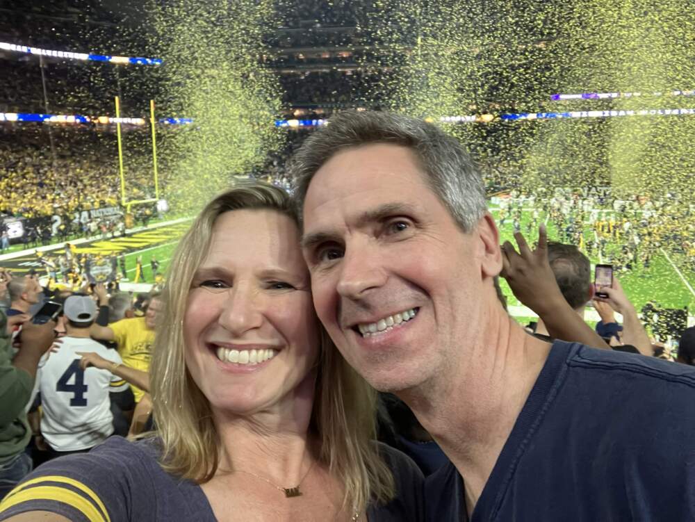 The author and her husband celebrate Michigan's beating the Washington Huskies 34-13 to win the National Championship in Houston, in January 2024. (Courtesy Laura McTaggart)