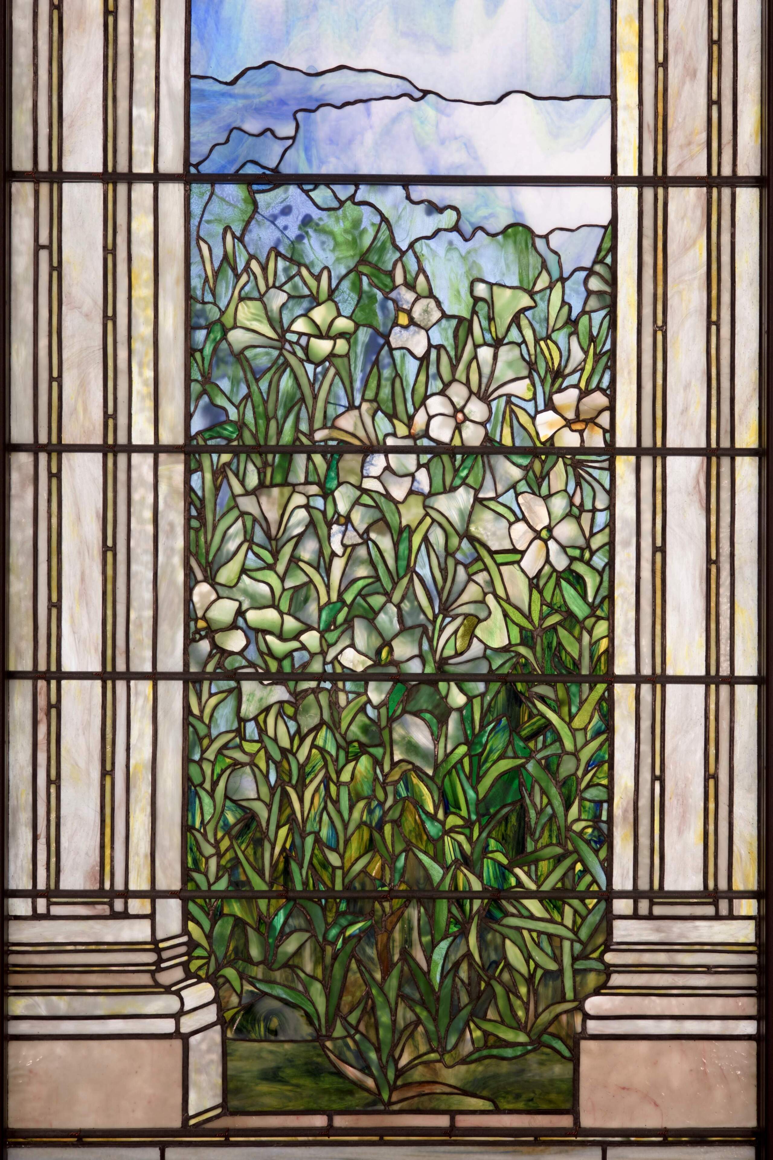 A detailed view of the "Easter Lily Window" panel from the "Angel of Resurrection" (1899) window created by Louis C. Tiffany. (Courtesy Worcester Art Museum)