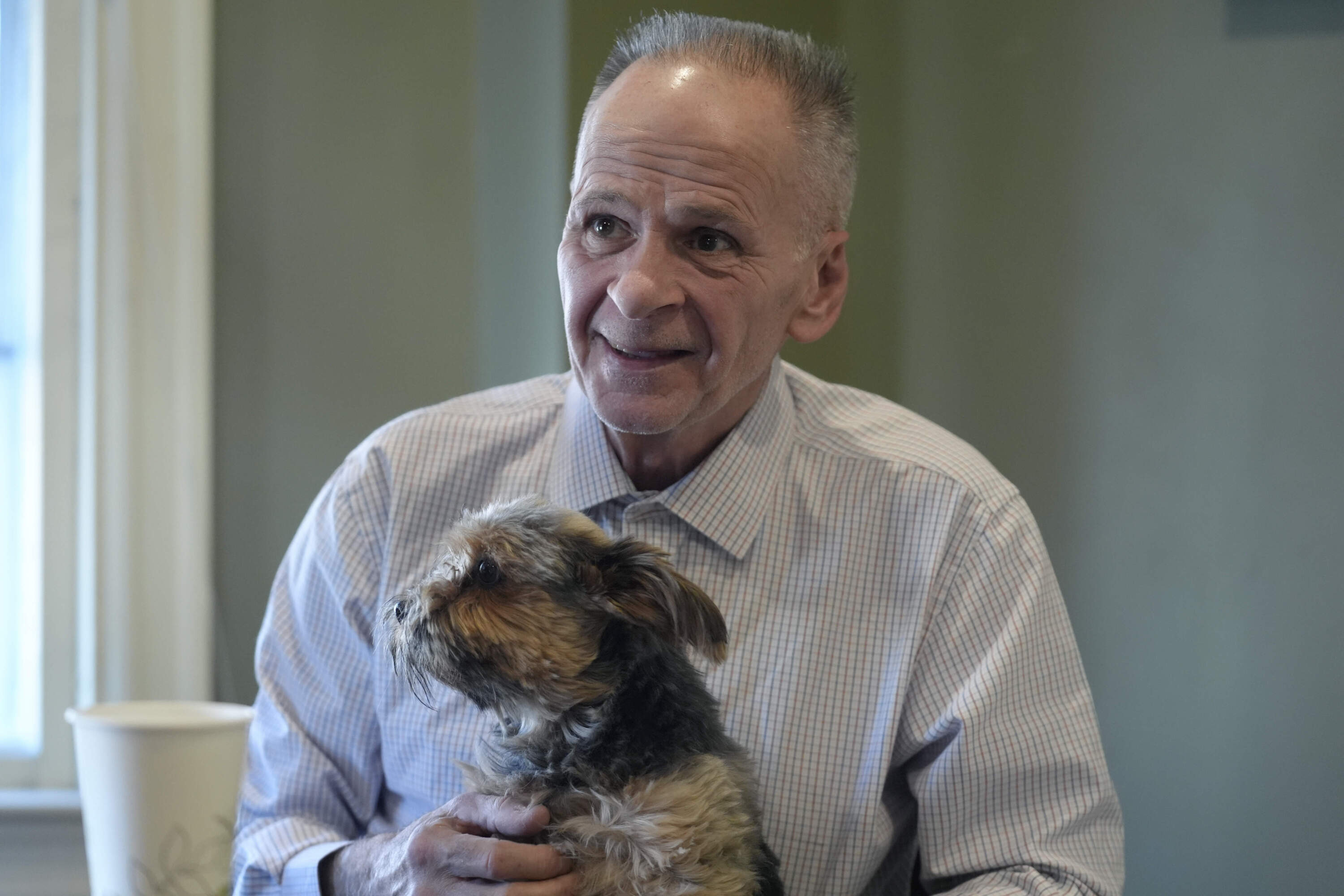 Michael Sullivan holds his six-year-old Yorkshire terrier "Buddy" while speaking with a reporter from at his attorney's office, Wednesday, Nov. 20, 2024, in Framingham, Mass. (Steven Senne/AP)