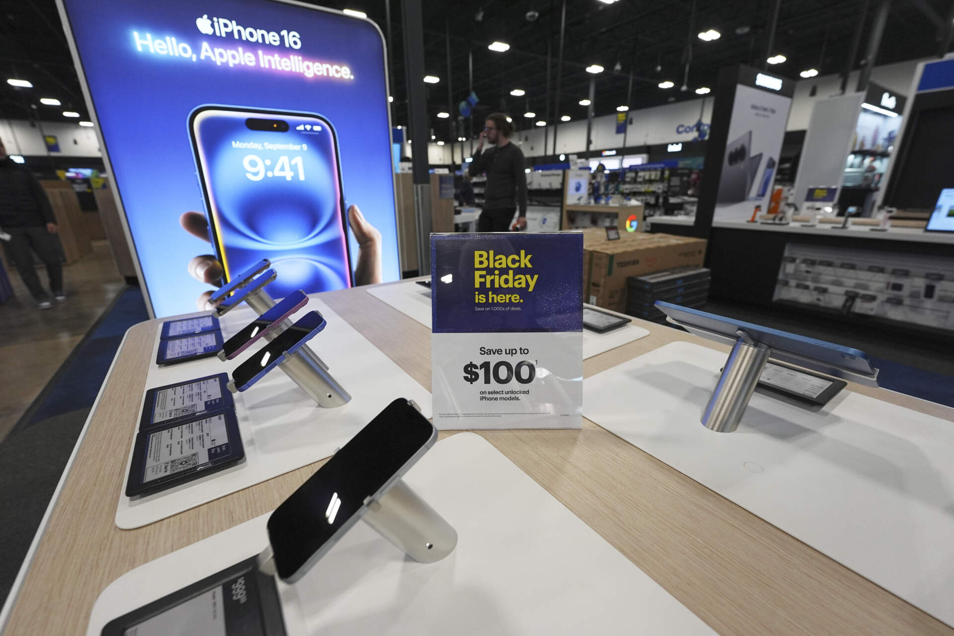Sign promoting Black Friday deals sits above mobile phones on display in a Best Buy store on Nov. 21 in Denver. (David Zalubowski/AP)