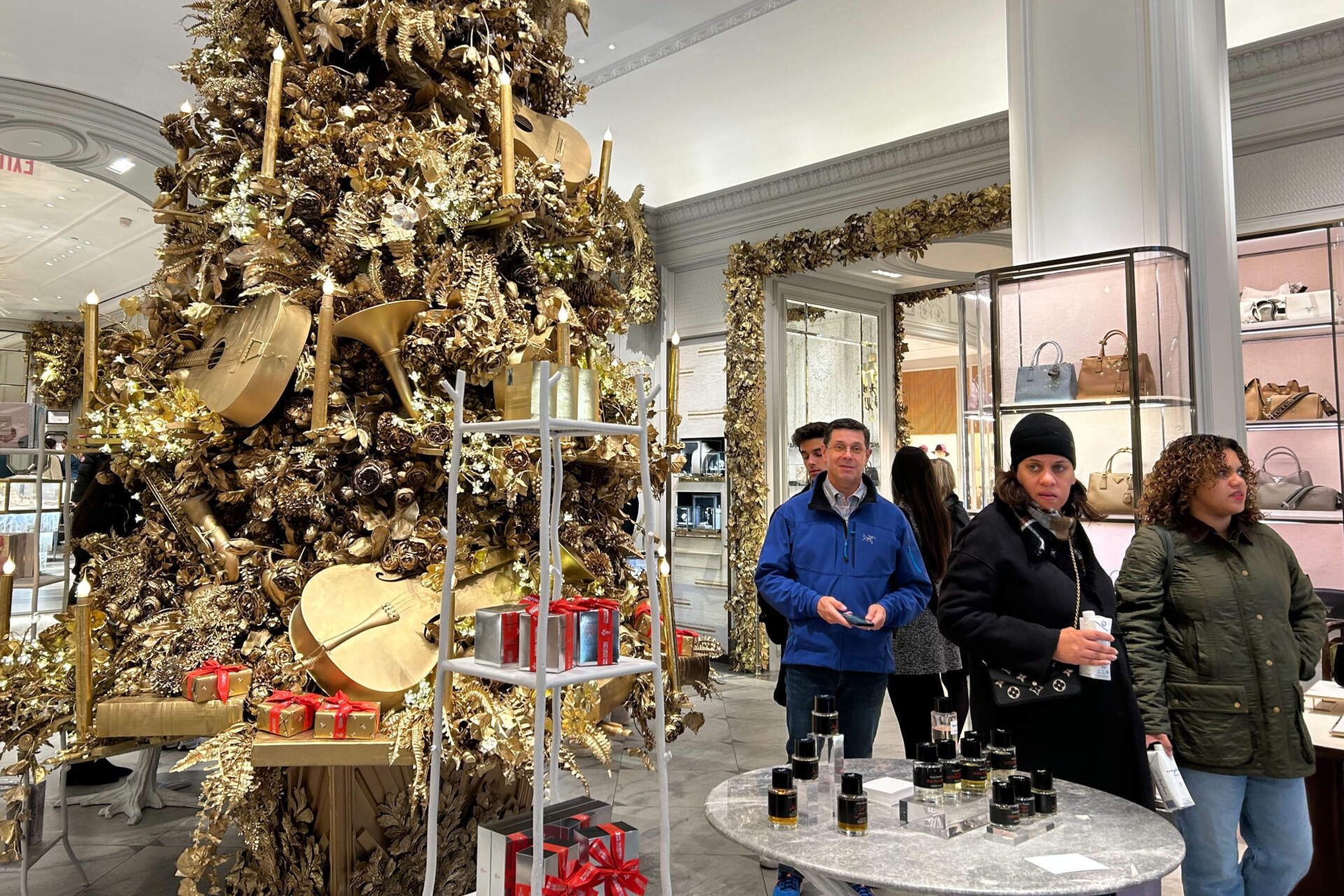 Shoppers pass a Christmas tree at the Bergdorf Goodman store on Nov. 24 in New York. (Anne D'Innocenzio/AP)