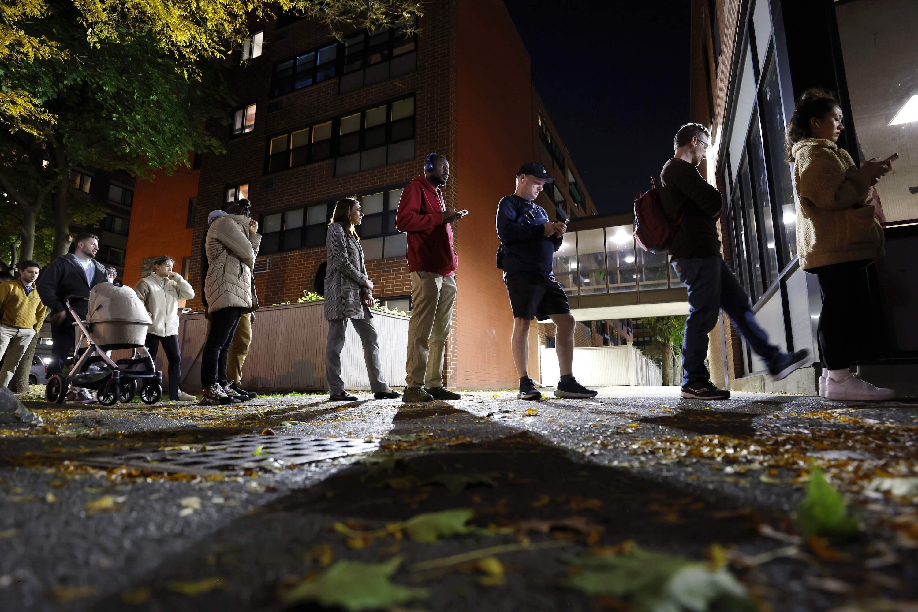 People wait in line to vote one hour before polls close on Election Day, Tuesday, Nov. 5, 2024, in the East Boston neighborhood of Boston. (AP Photo/Michael Dwyer)