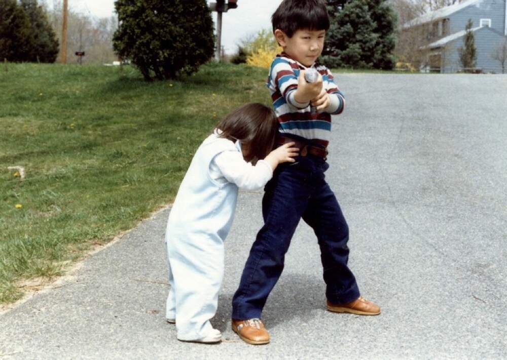 The author as a child playing with his sister outside their home in Concord, Massachusetts, 1984. (Courtesy of Gene Yu)