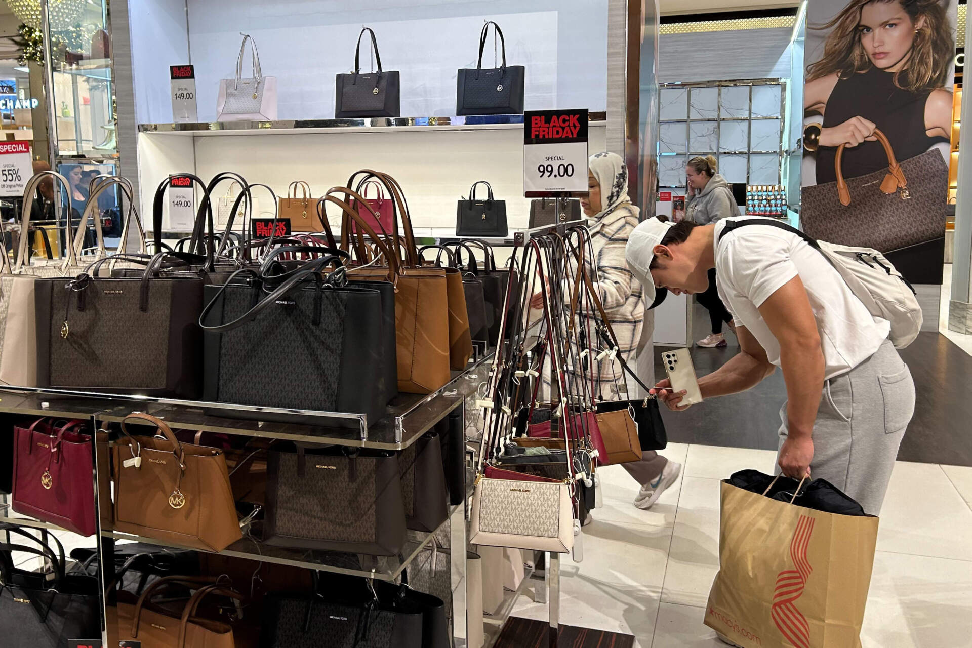 A shopper looks at handbags at Macy's department store on Nov. 24 in New York. (Anne D'Innocenzio/AP)