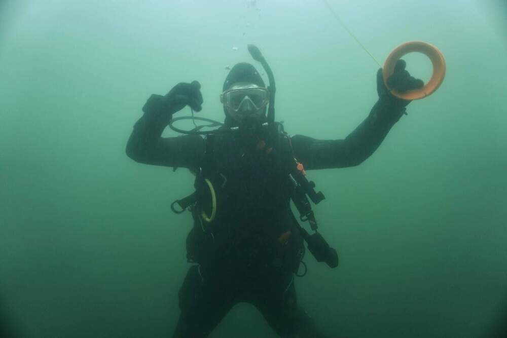 Diver Zach Talmadge holds on to the line that he'll use to attached to the abandoned lobster traps that he's found on the seafloor. (Courtesy of Noah Oppenheim)