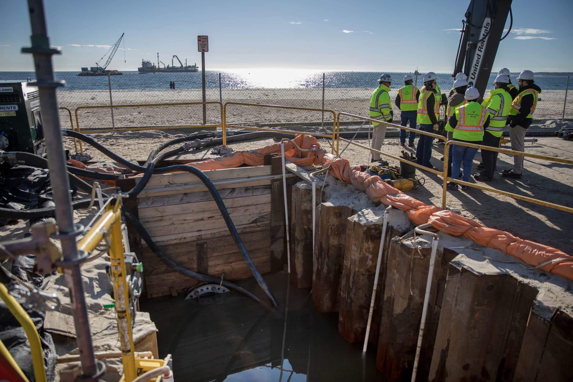 One of the cables that will carry power form Vineyard Wind's turbines comes ashore in a trench at Covell's Beach. (Robin Lubbock/WBUR)
