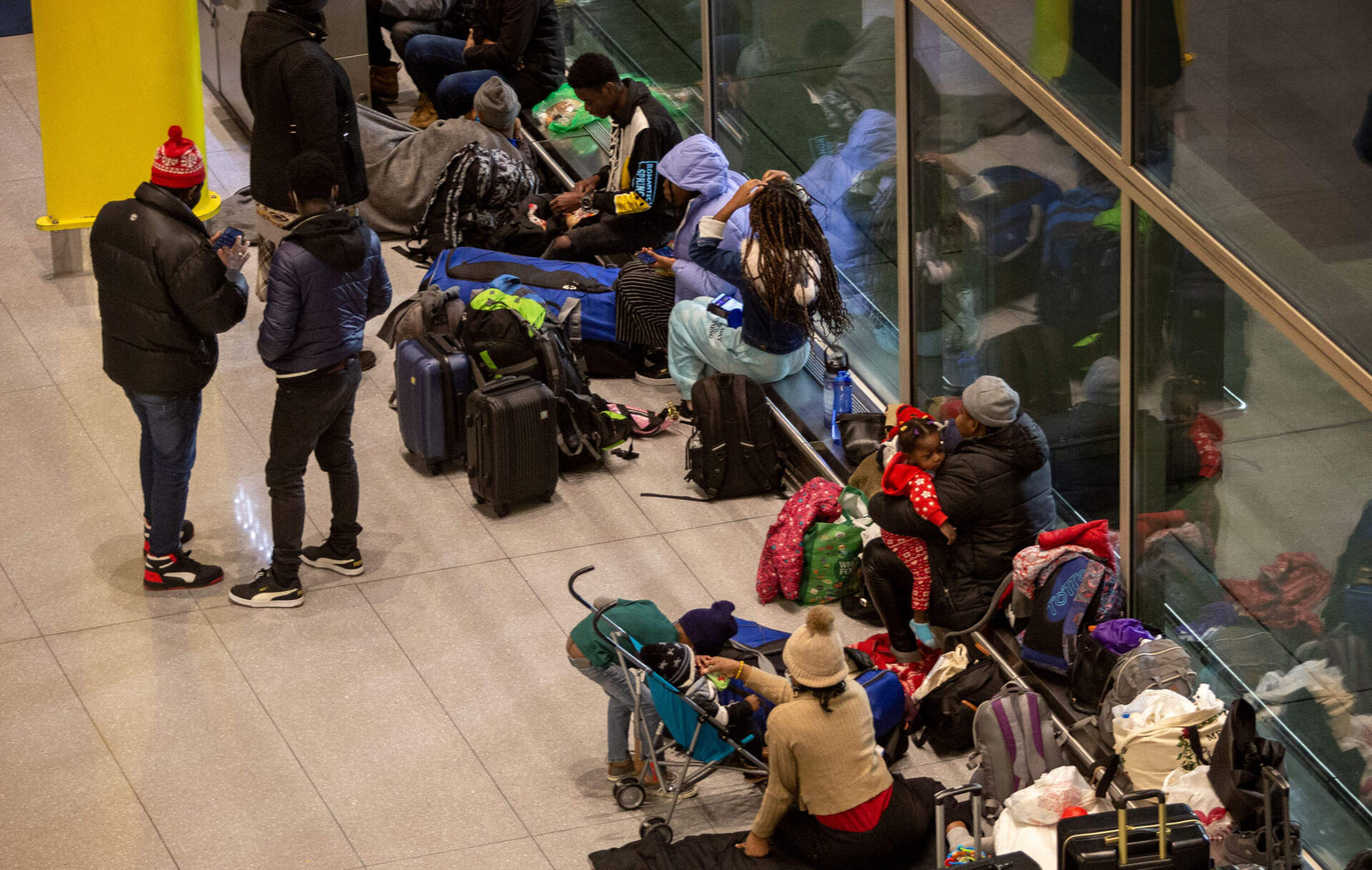 Families without without anywhere to stay, settle down for the night at Boston's Logan Airport. (Robin Lubbock/WBUR)