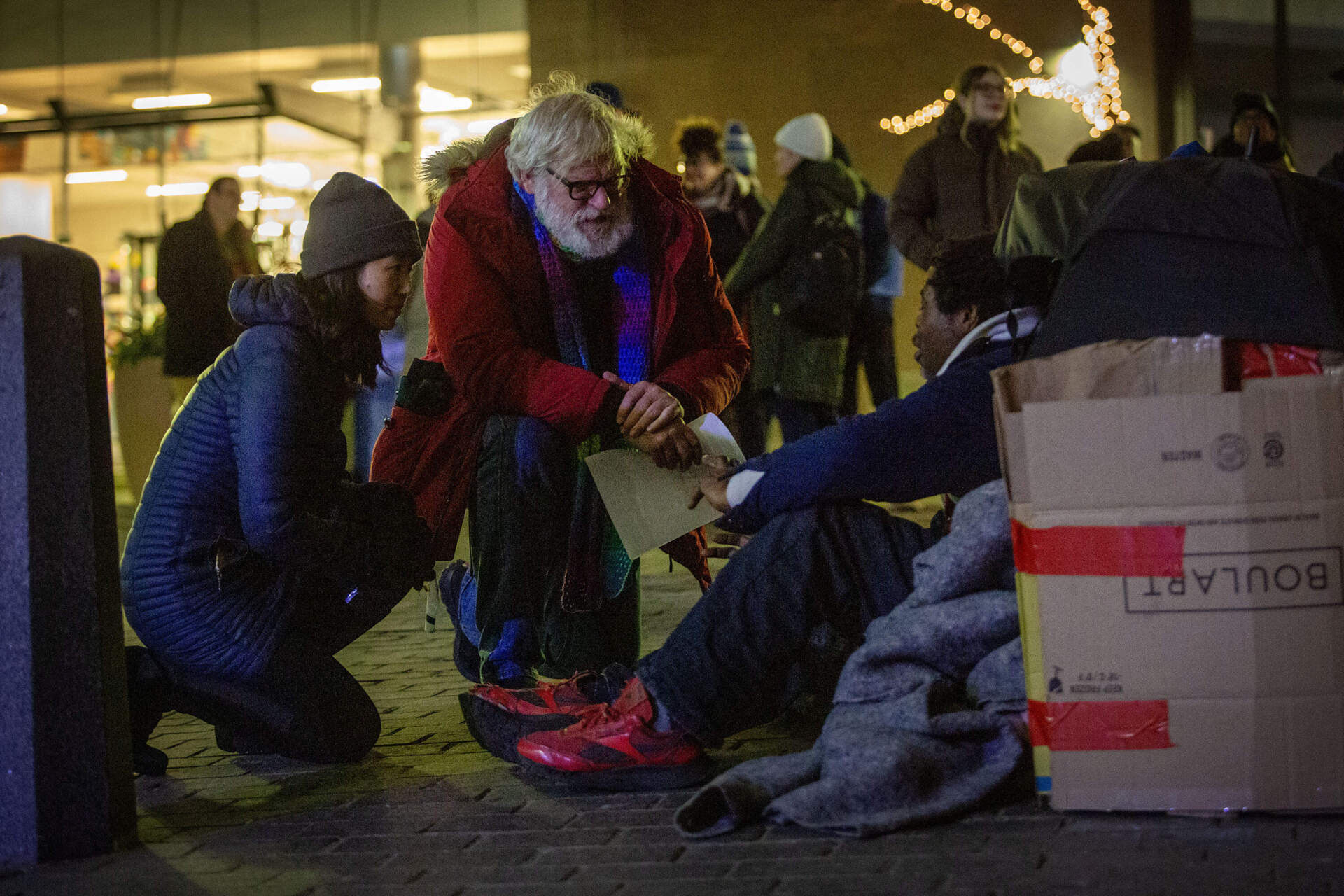 During Boston's annual homeless census, Mayor Michelle Wu and Jim Greene, the city's assistant director of street homelessness initiatives, talk with a man who's spending the night next to the Old State House.