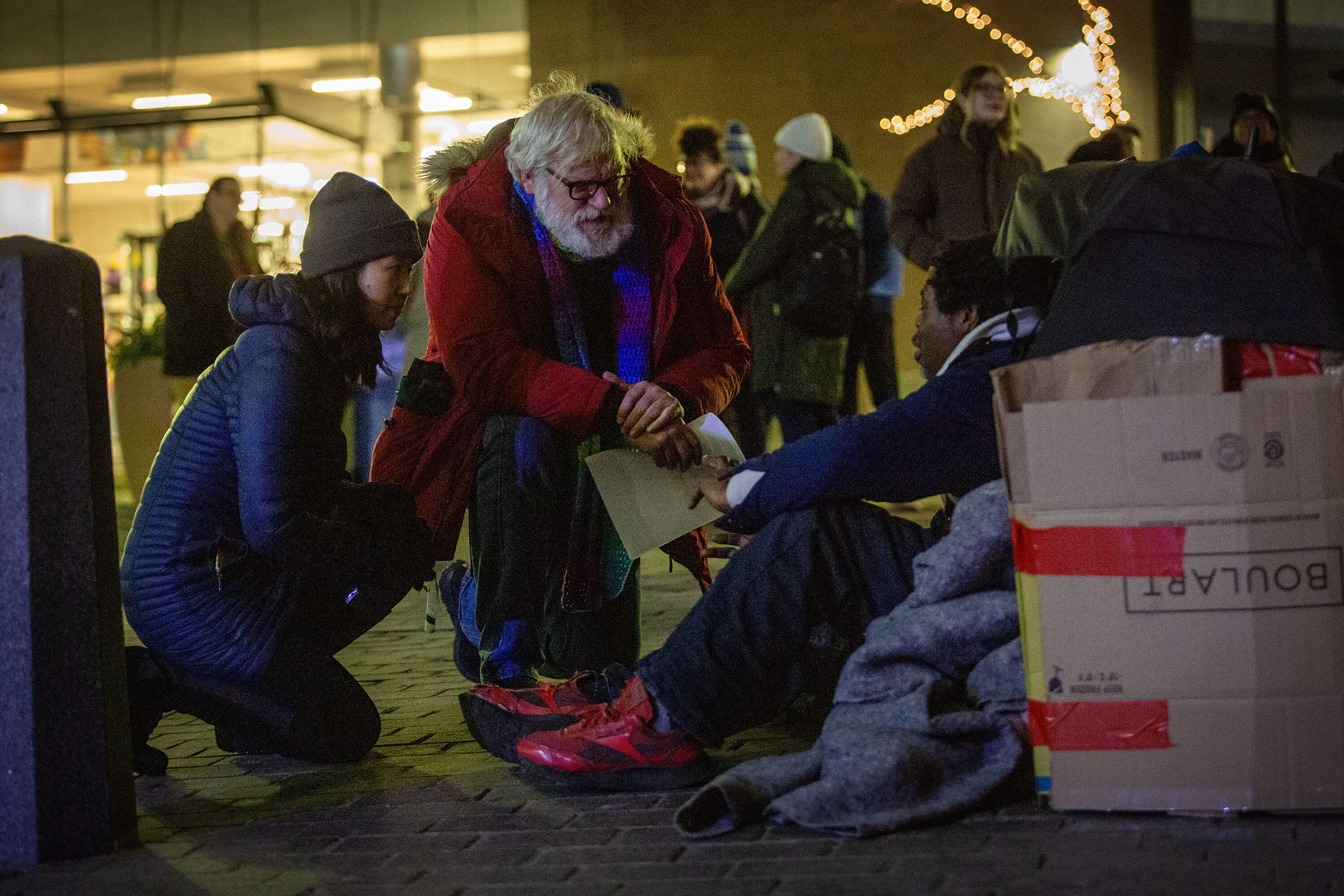 During Boston's annual homeless census, Mayor Michelle Wu and Jim Greene, the city's assistant director of street homelessness initiatives, talk with a man who's spending the night next to the Old State House.