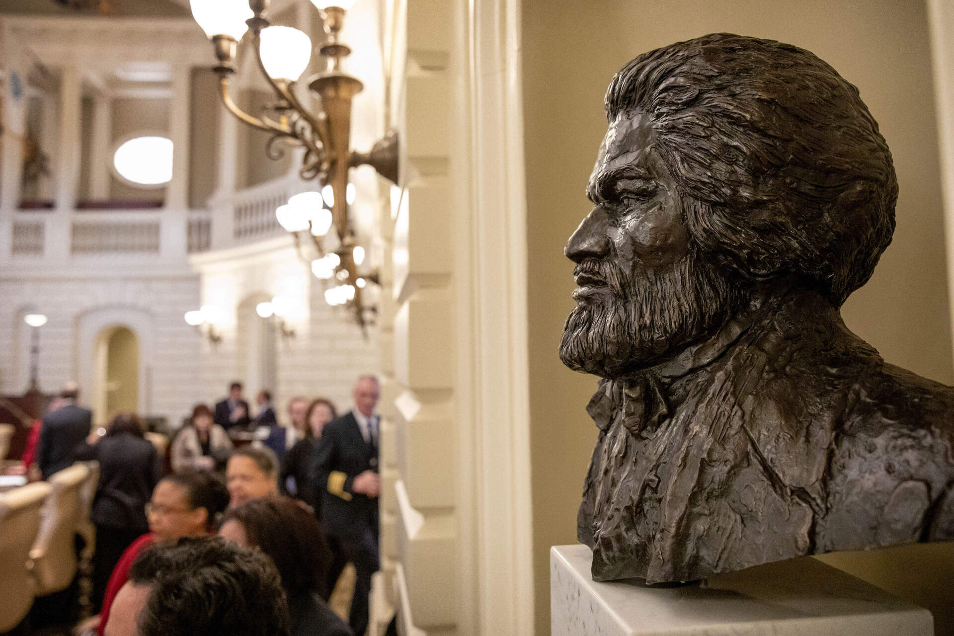 The newly installed bust of Frederick Douglass looks out across the Massachusetts State House Senate Chamber.