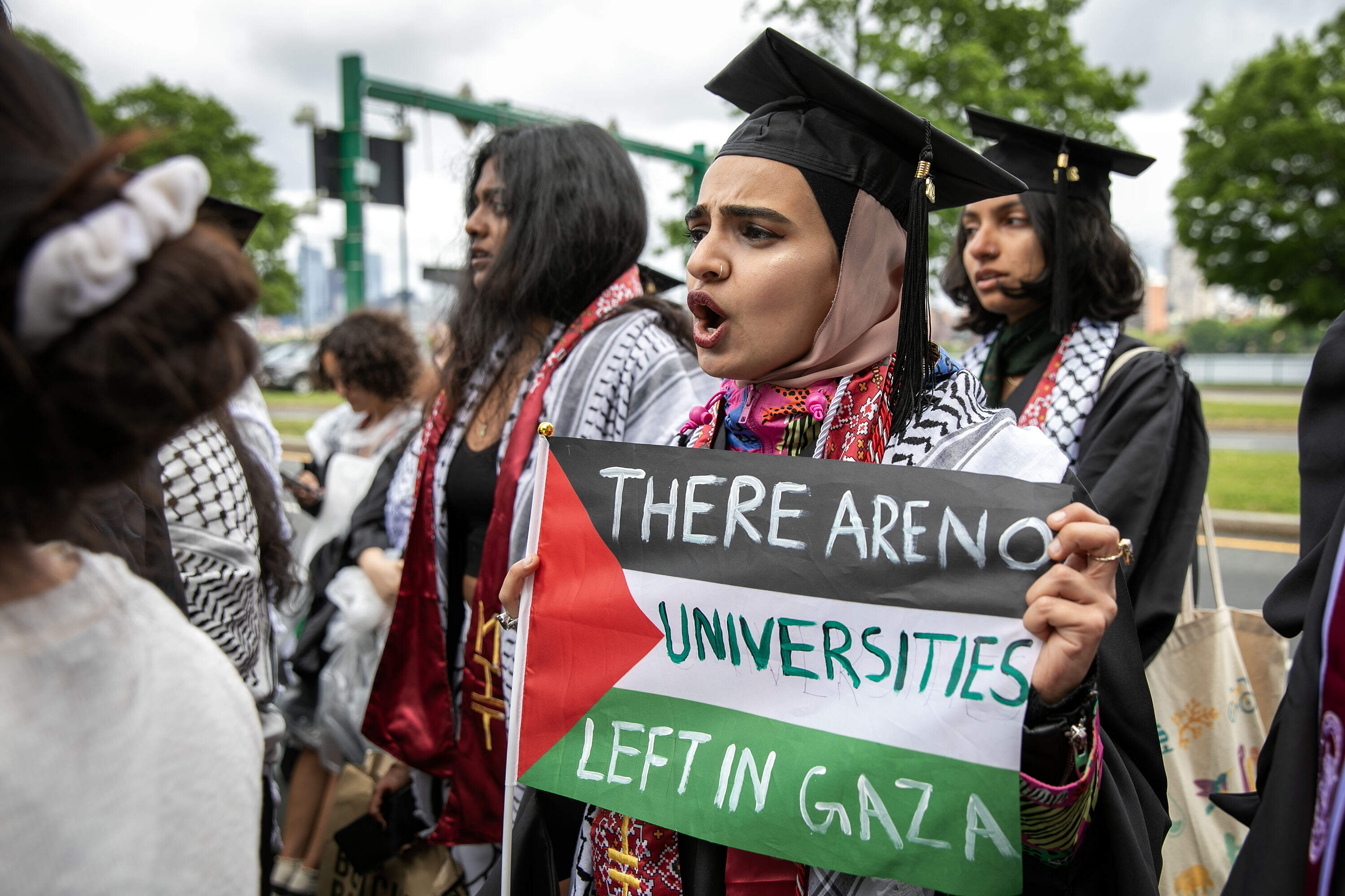 Graduates protesting the war in Gaza walk out of MIT's commencement ceremony.