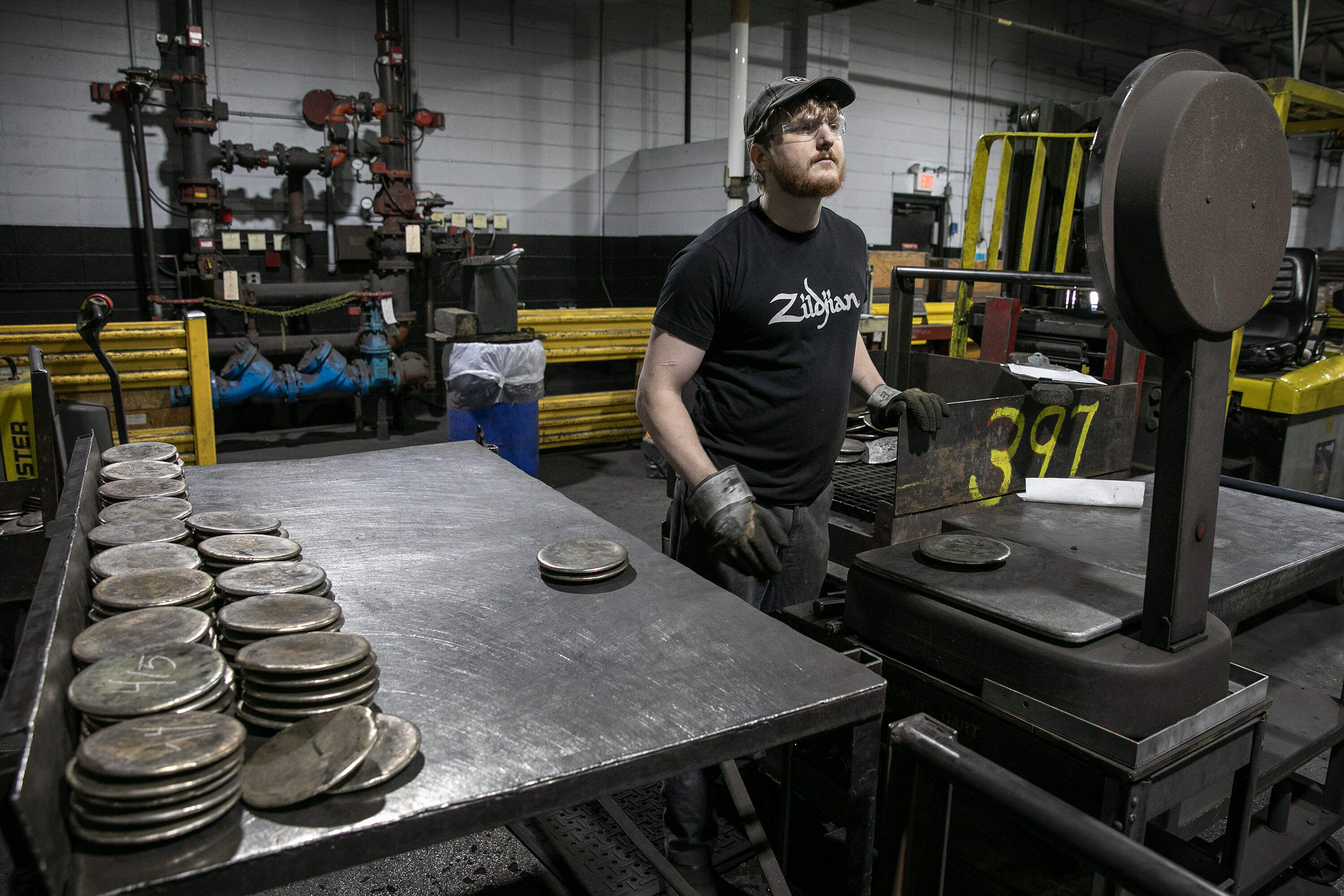 Eliot Carduff weighs and sorts castings, that will soon become cymbals. (Robin Lubbock/WBUR)