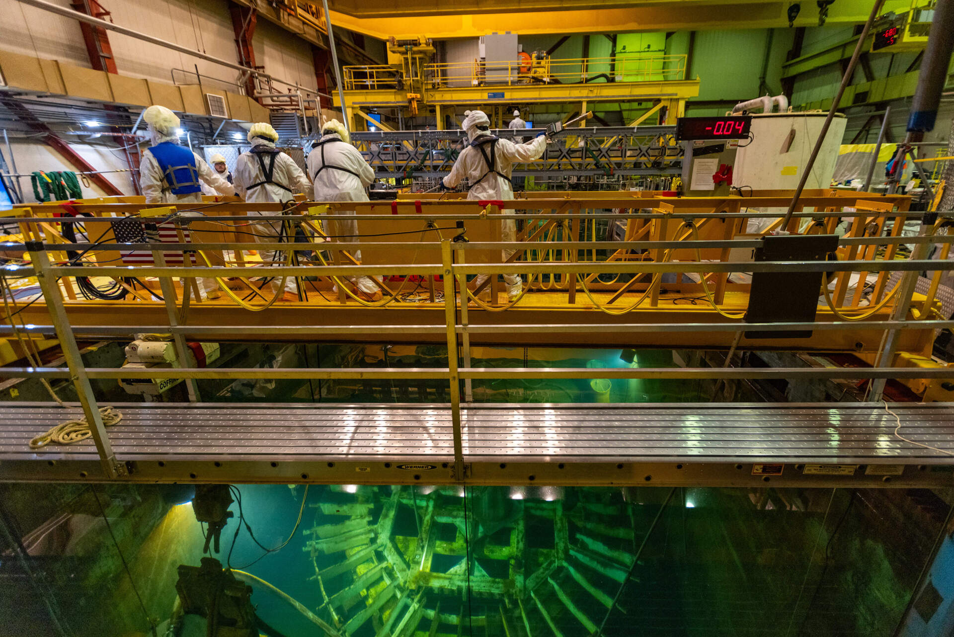 A decommissioning crew works in the dryer separator pit filled with filtered wastewater in the Pilgrim Nuclear Power Station reactor.