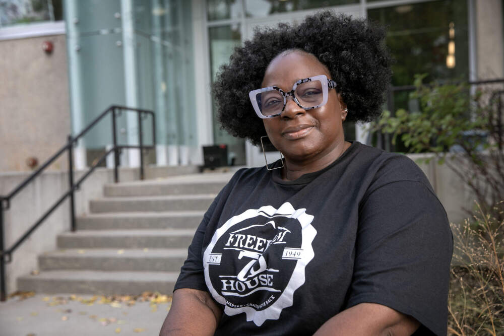 Freedom House Chief Executive Officer Charmaine Arthur sits outside the organization's building in Dorchester, Mass. (Robin Lubbock/WBUR)