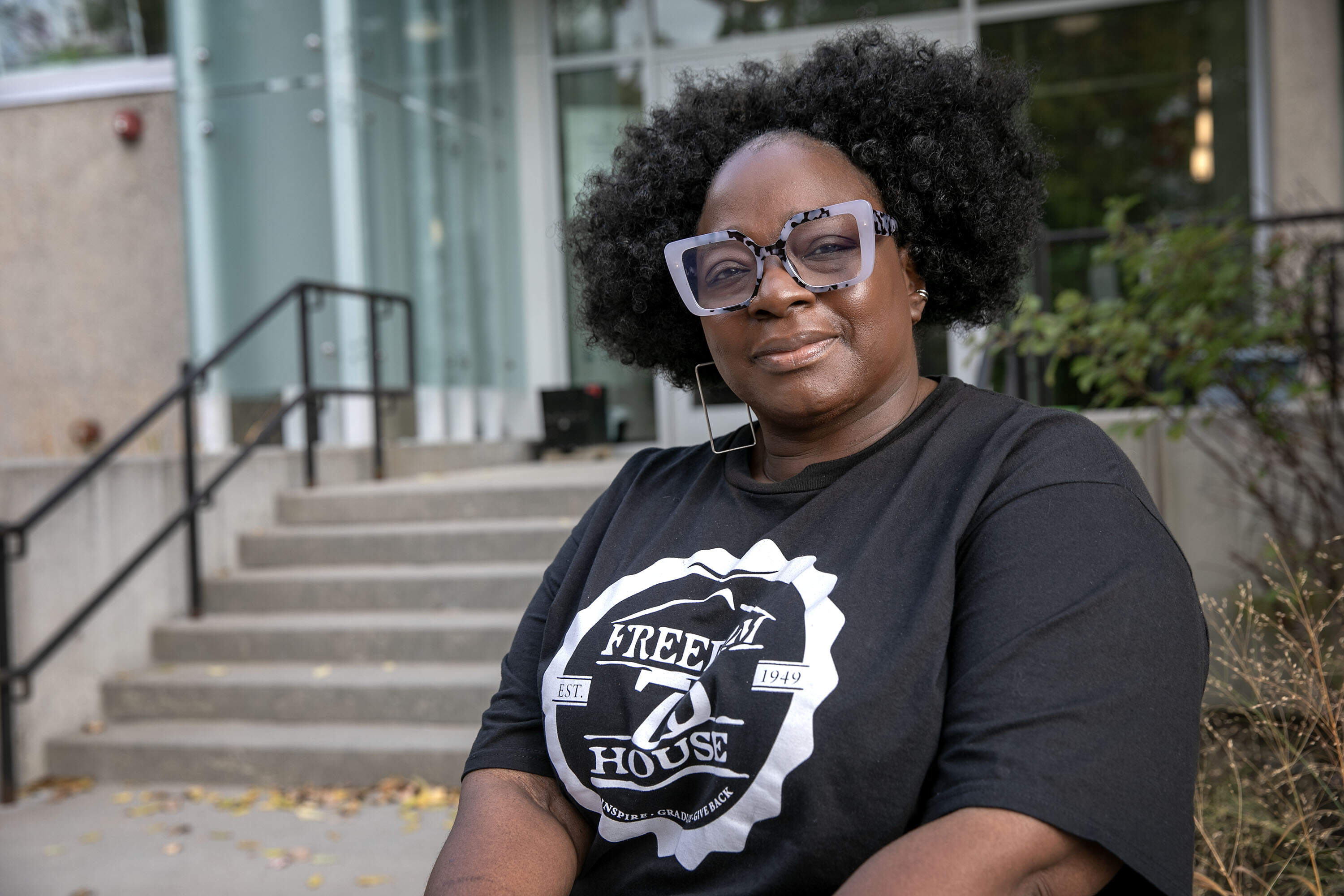 Freedom House Chief Executive Officer Charmaine Arthur sits outside the organization's building in Dorchester, Mass. (Robin Lubbock/WBUR)