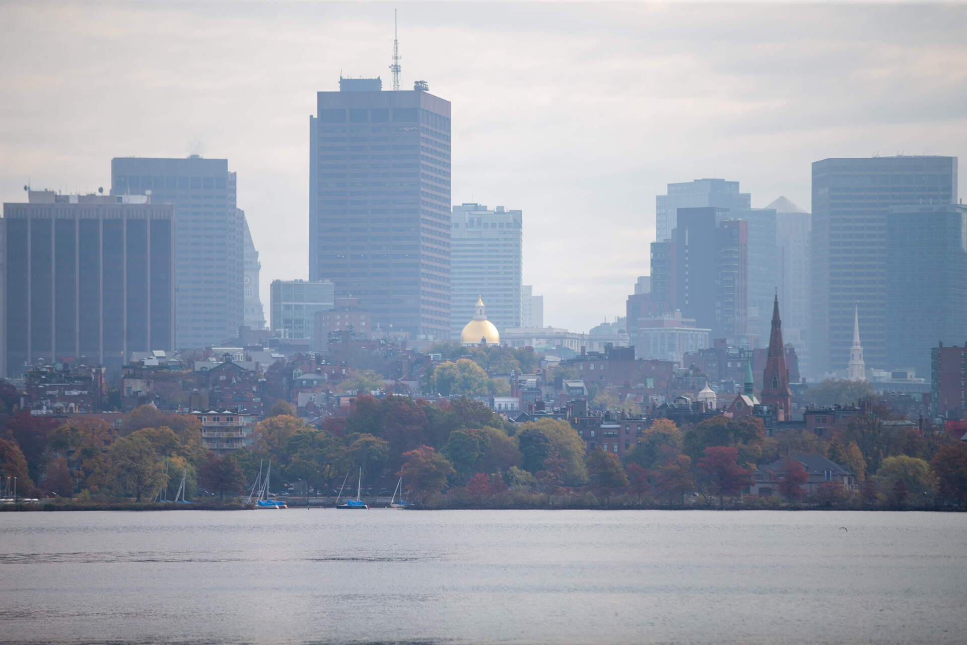 The Massachusetts State House and Beacon Hill enveloped by smoke from brush fires around Greater Boston on Monday morning.