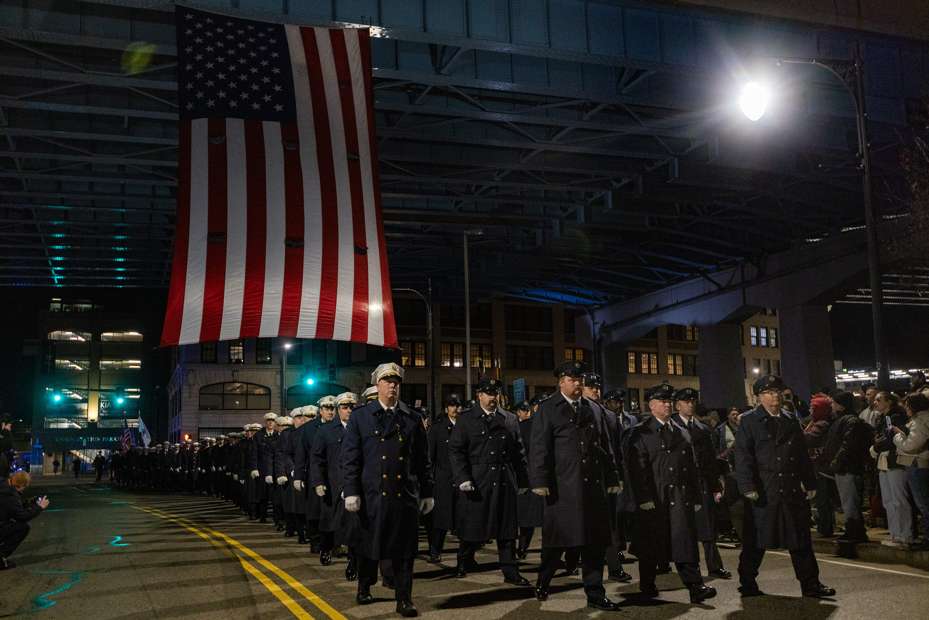 Worcester firefighters march towards Franklin Street Firehouse, the site of the former Worcester Cold Storage and Warehouse building. (Jesse Costa/WBUR)