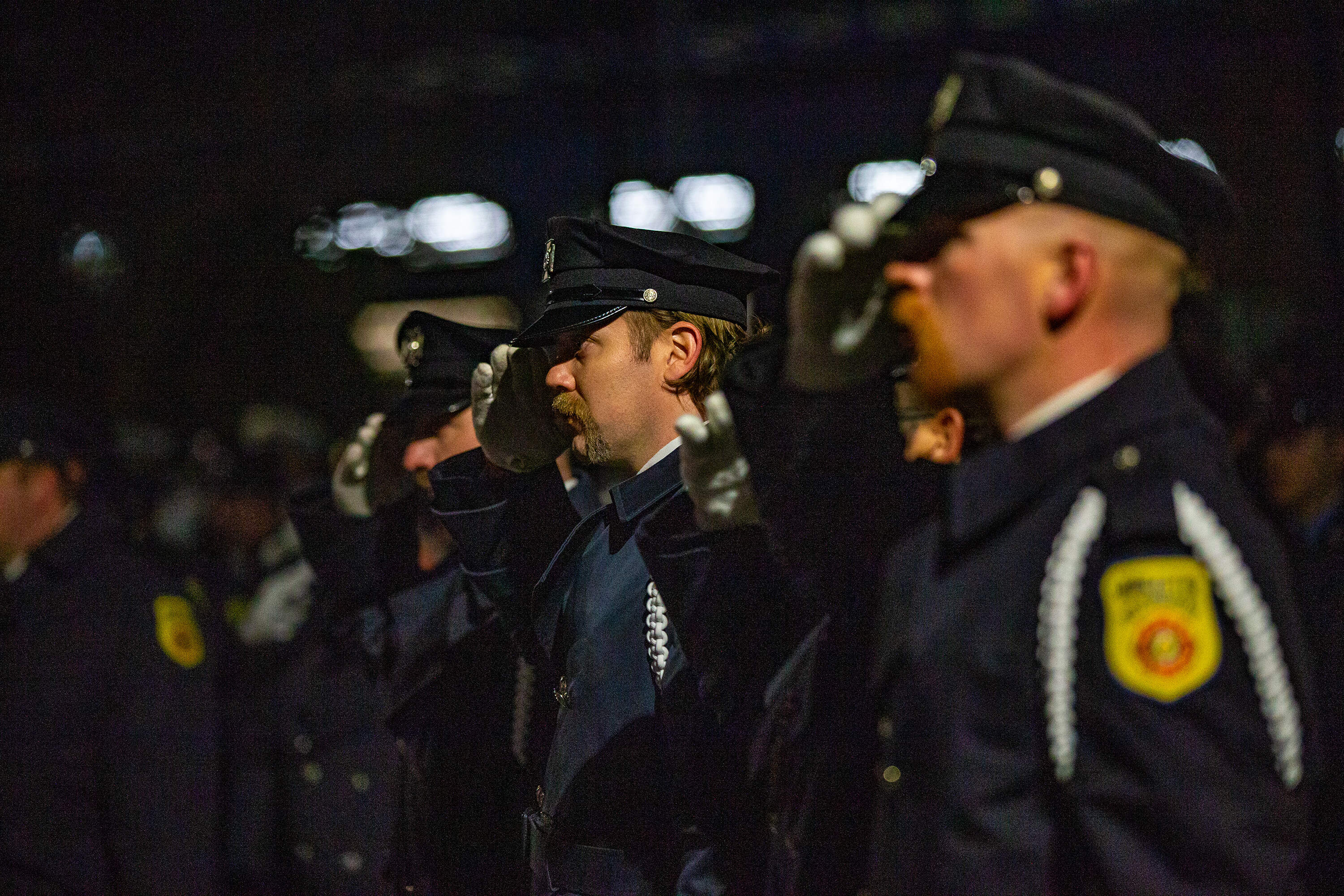 Worcester firefighters salute during the ceremony. (Jesse Costa/WBUR)