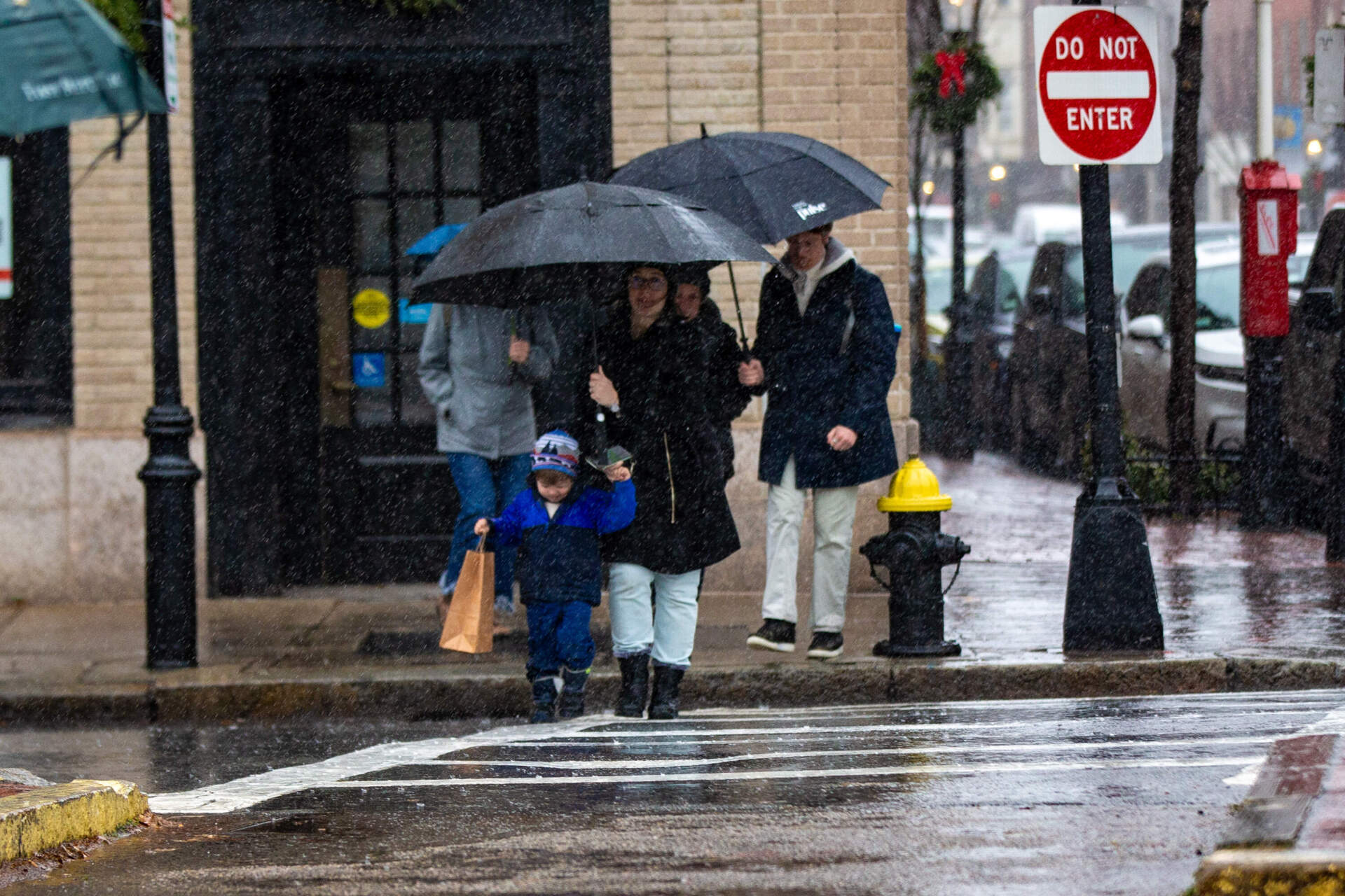 Pedestrians cross Beacon Street on Wednesday. (Jesse Costa/WBUR)