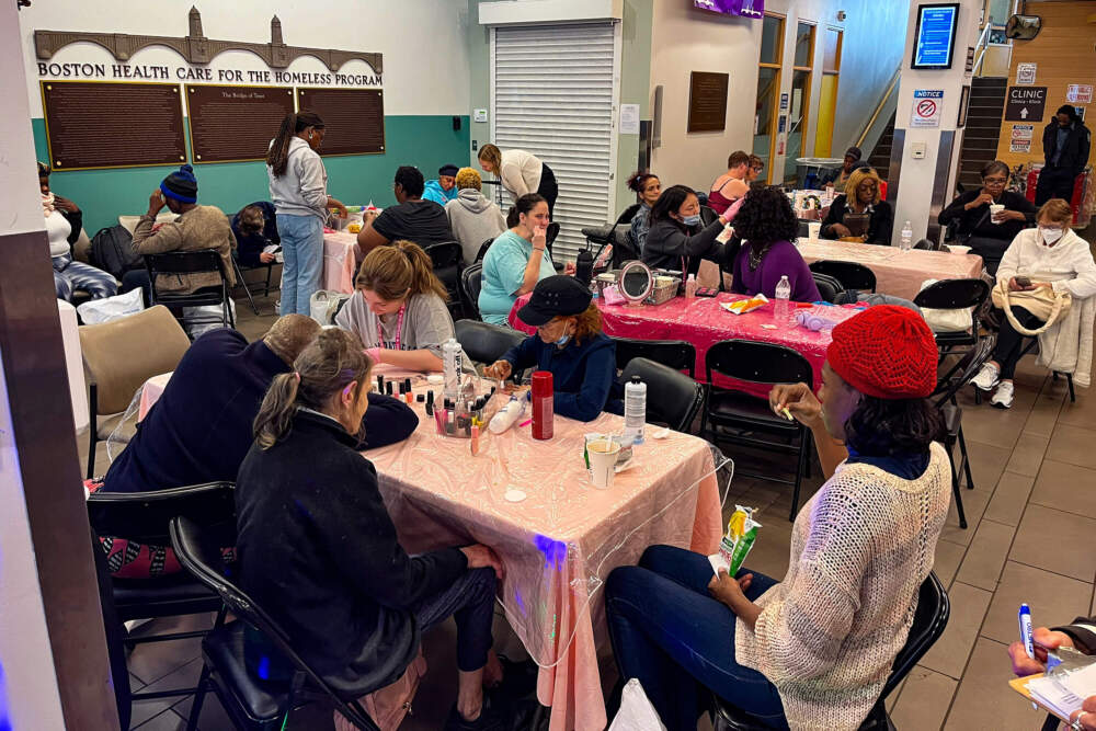 Women do makeup and nails, eat snacks and work on crafts at the event. (Lynn Jolicoeur/WBUR)