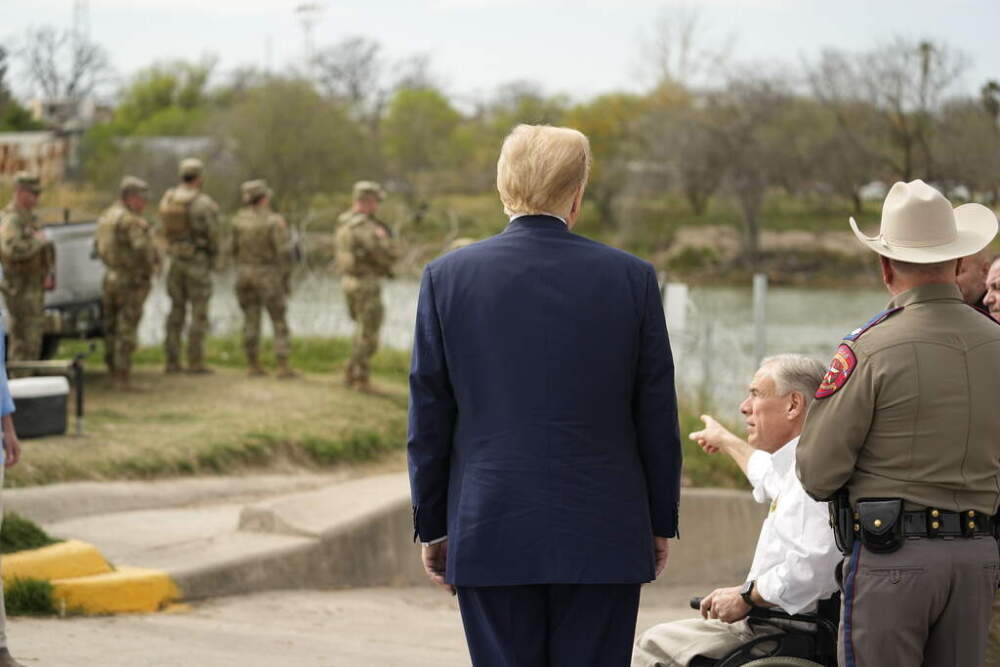 Republican presidential candidate former President Donald Trump listens as Texas Gov. Greg Abbott speaks as he visits the boat ramp at Shelby Park during a visit to the U.S.-Mexico border, Thursday, Feb. 29, in Eagle Pass, Texas. (Eric Gay/AP)