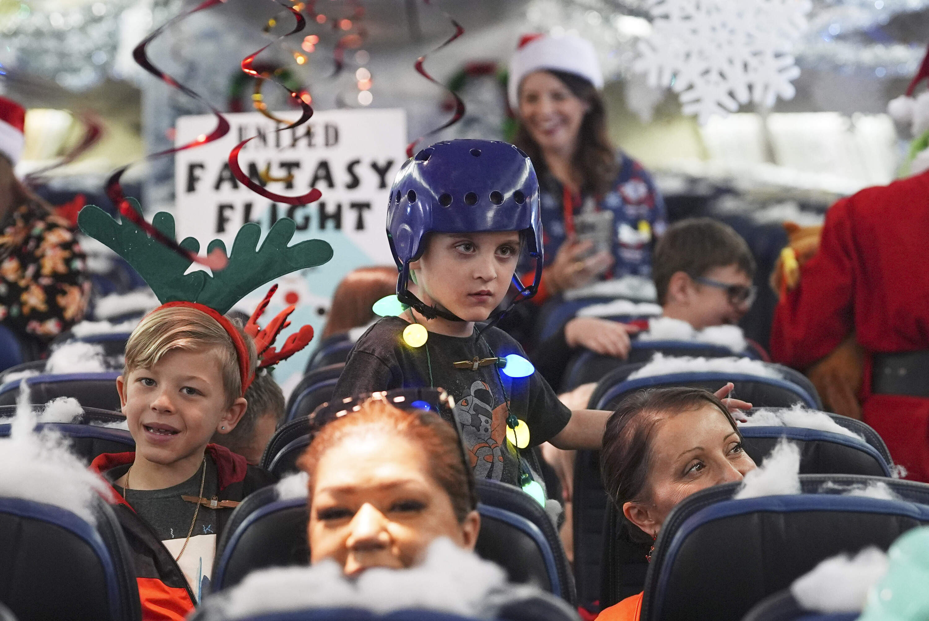 Participants prepare for take off during the United Airlines annual "fantasy flight" to a fictional North Pole at Denver International Airport, Saturday, Dec. 14, 2024. (David Zalubowski/AP)