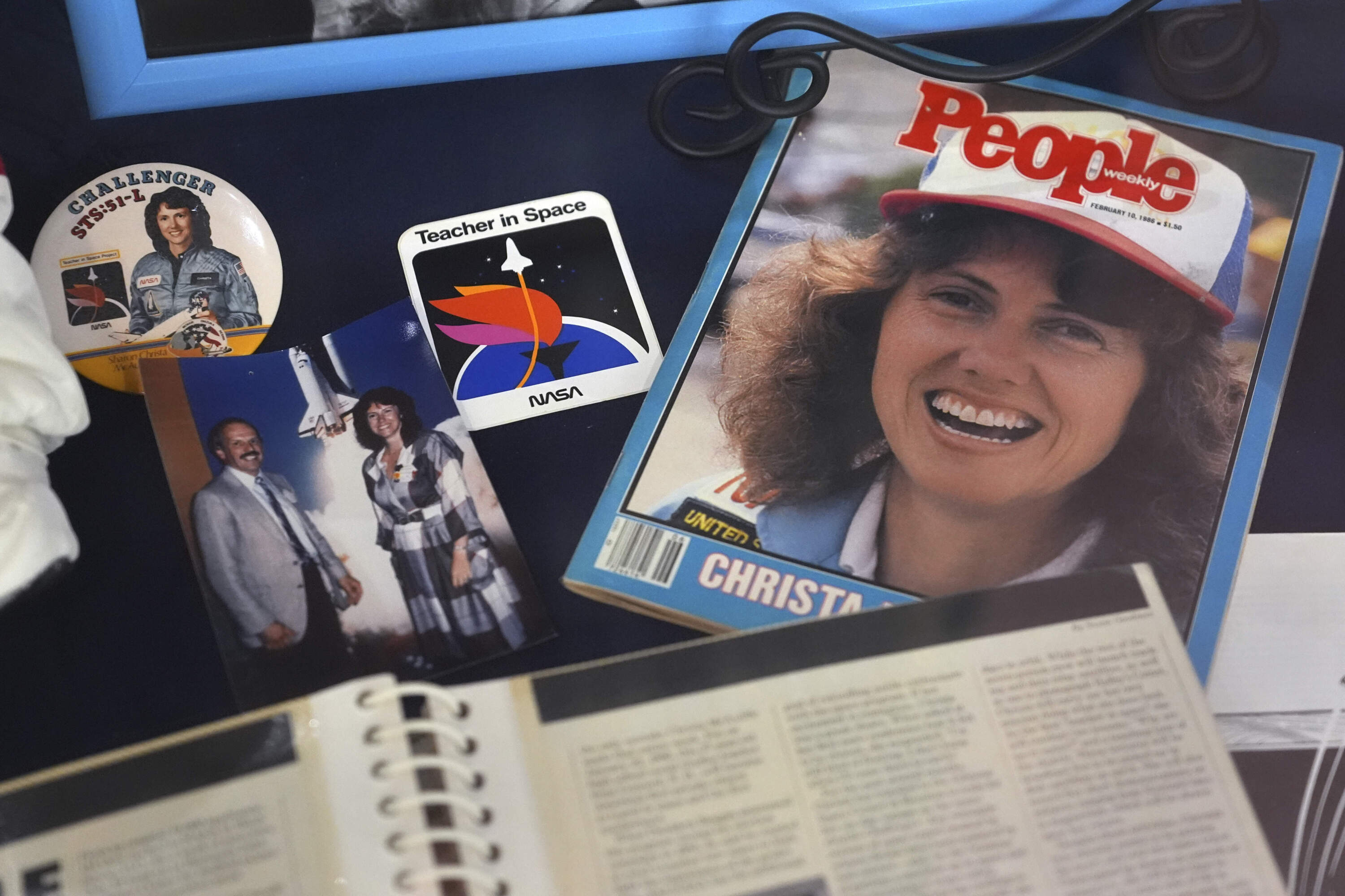 A selection of memorabilia featuring Christa McAuliffe, NASA's first teacher in space, is displayed at the McAuliffe-Shepard Discovery Center, Monday, Dec. 16, 2024, in Concord, N.H. (Charles Krupa/AP)